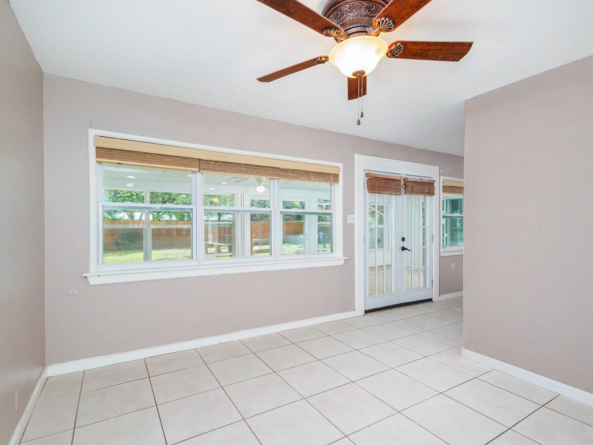 second dining area with enclosed sunroom and the backyard.