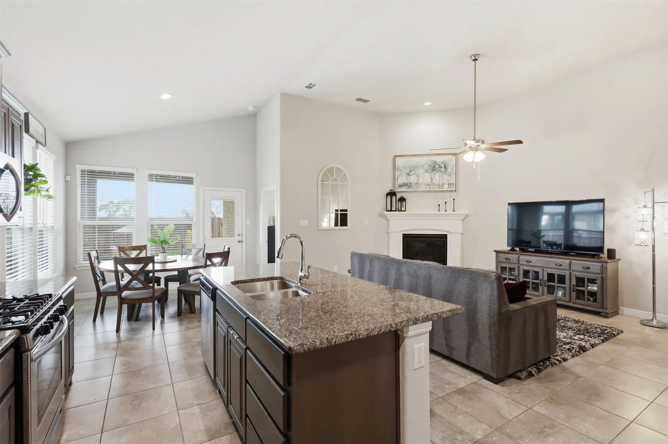 Open-concept interior featuring vaulted ceilings and tile flooring throughout