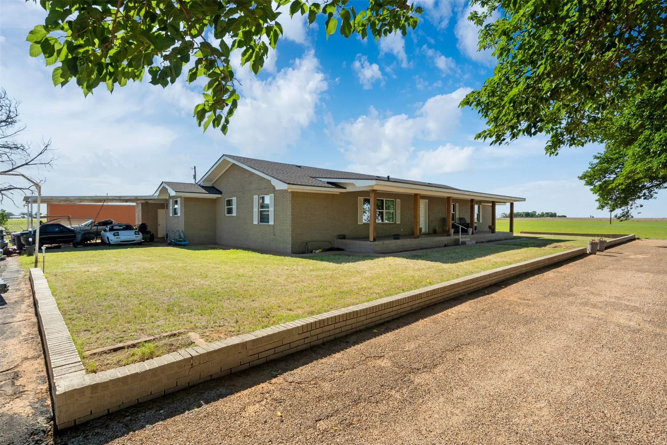 Showing a large amount of parking area.  Parking space is abundant in the front of the house and also a large paved area to the North side of the front yard.