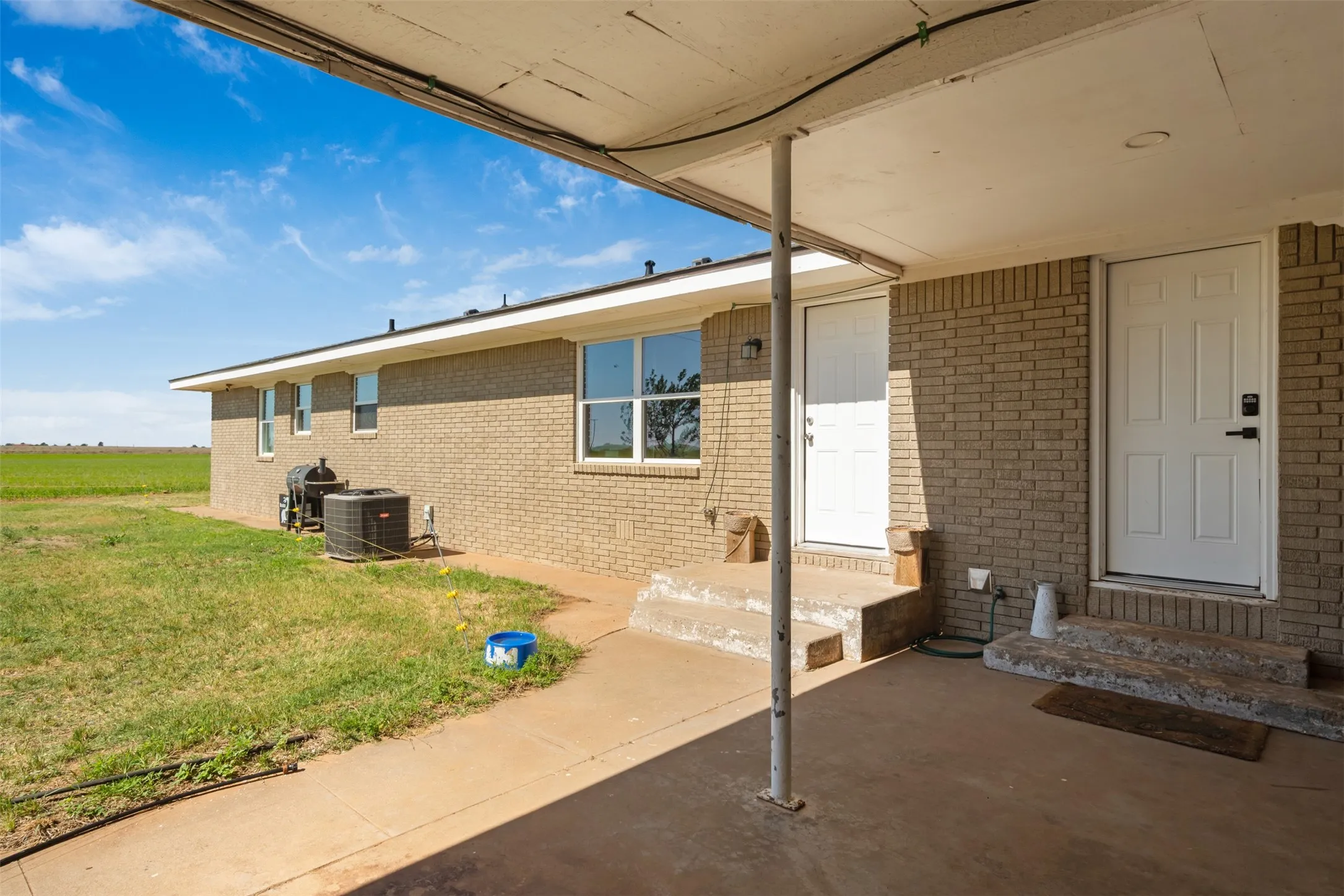 Covered area with doors leading into the utility room or into the living area of the home.  Also provides a place for more parking