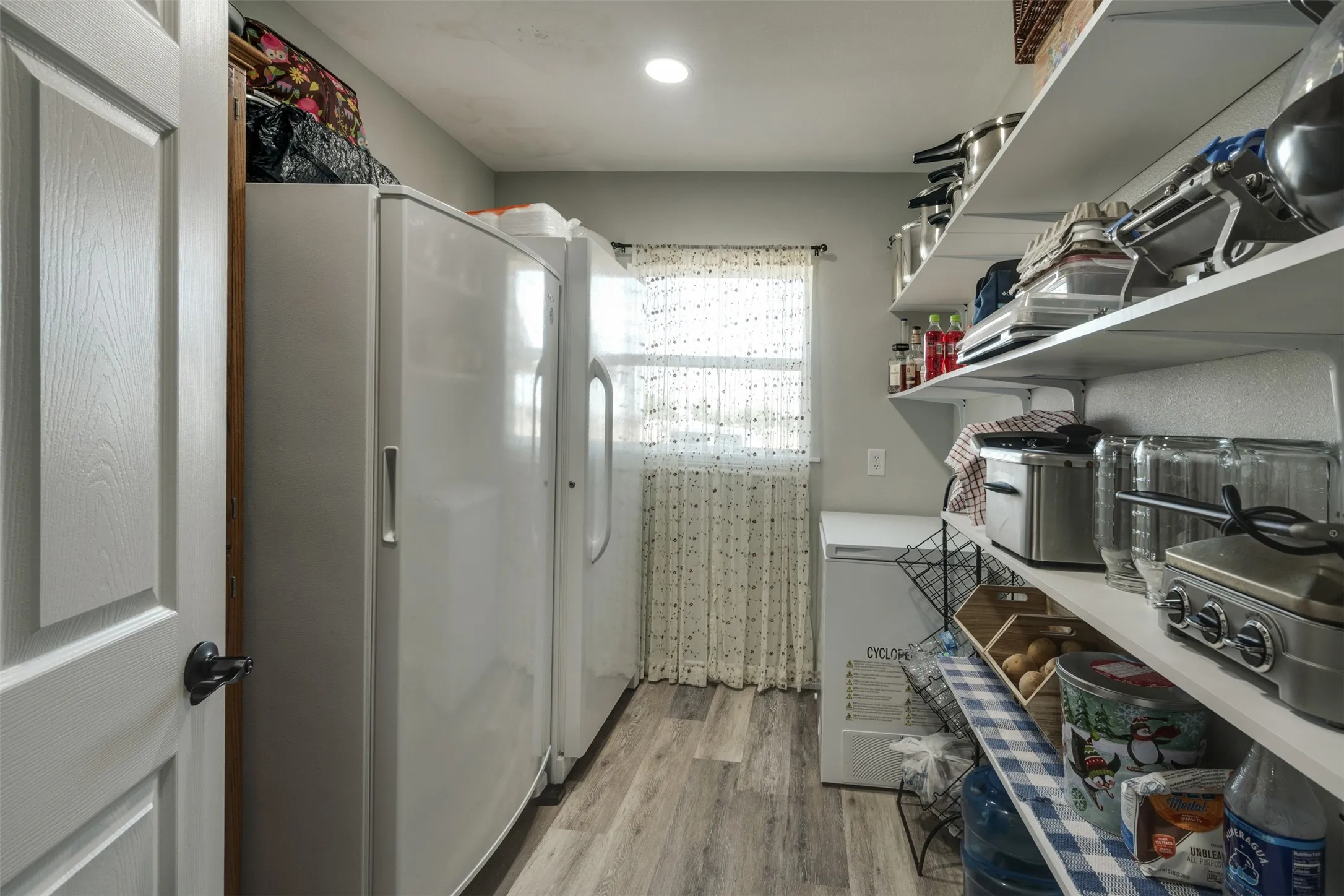 Large walk in pantry with abundance of shelves and space for extra freezers, refrigerators, etc.