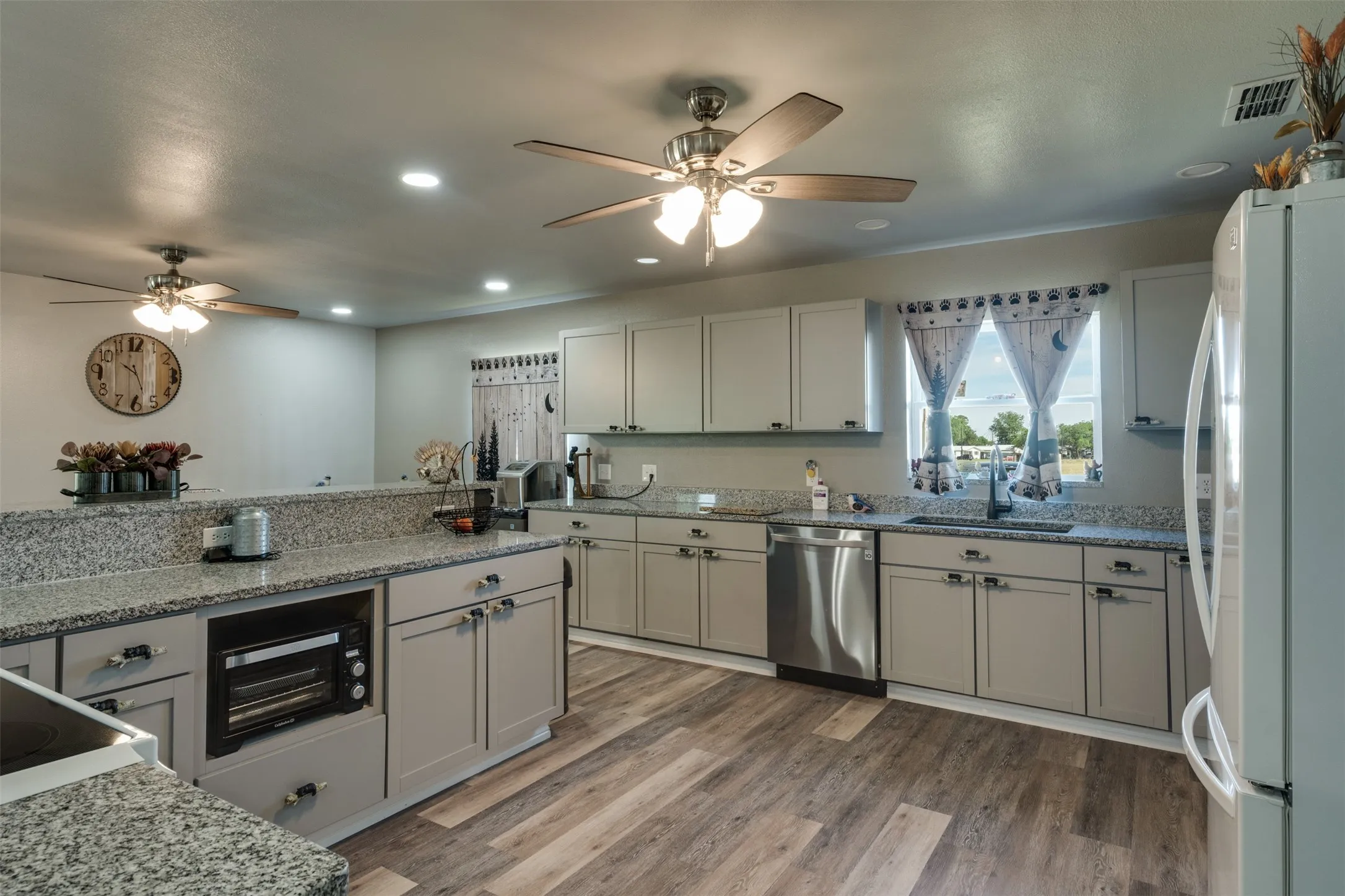 Solid surface countertops.  Updated cabinets. Stainless steel dishwasher.  View out the kitchen sink windows.