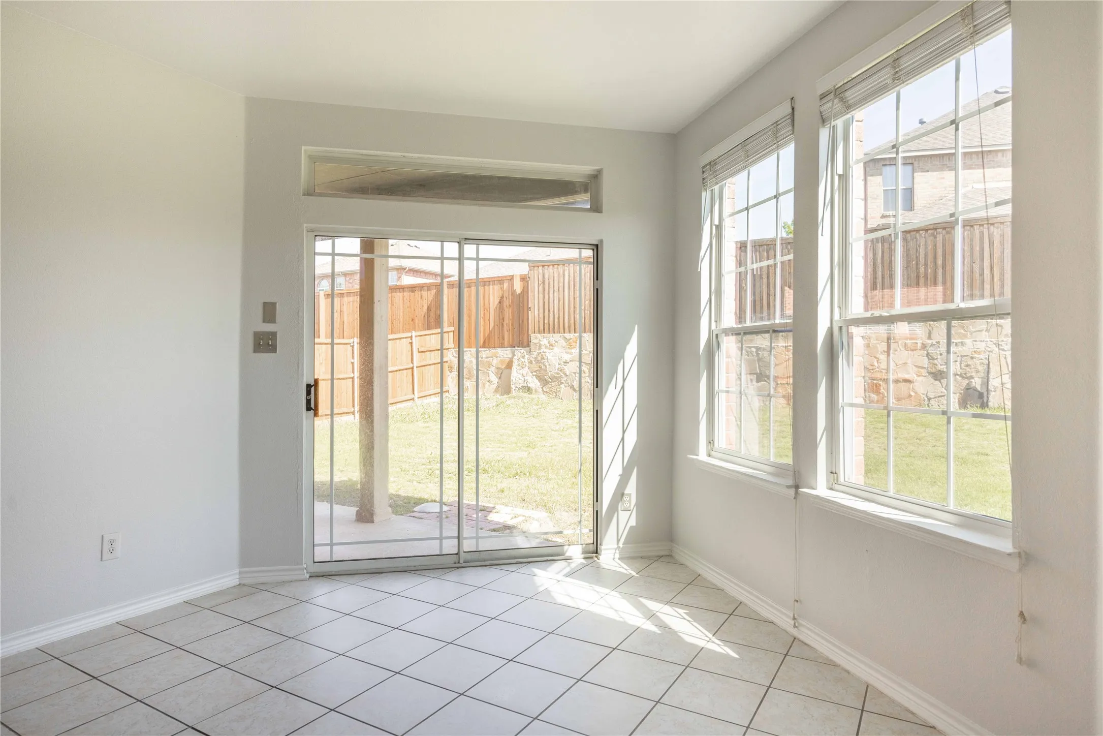 Room with white tile flooring and white baseboards
