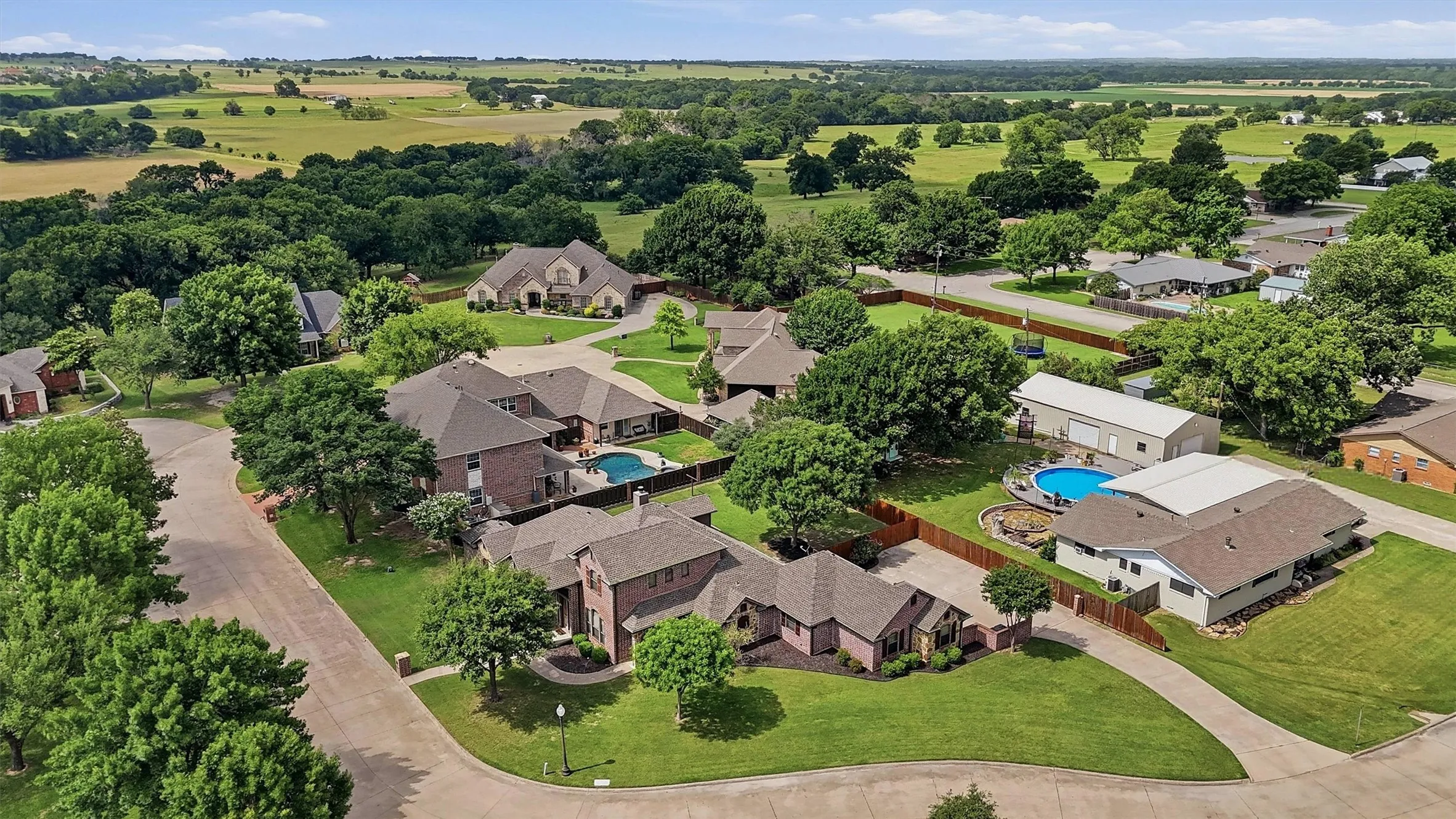 Aerial perspective showcasing a residential community with abundant mature trees