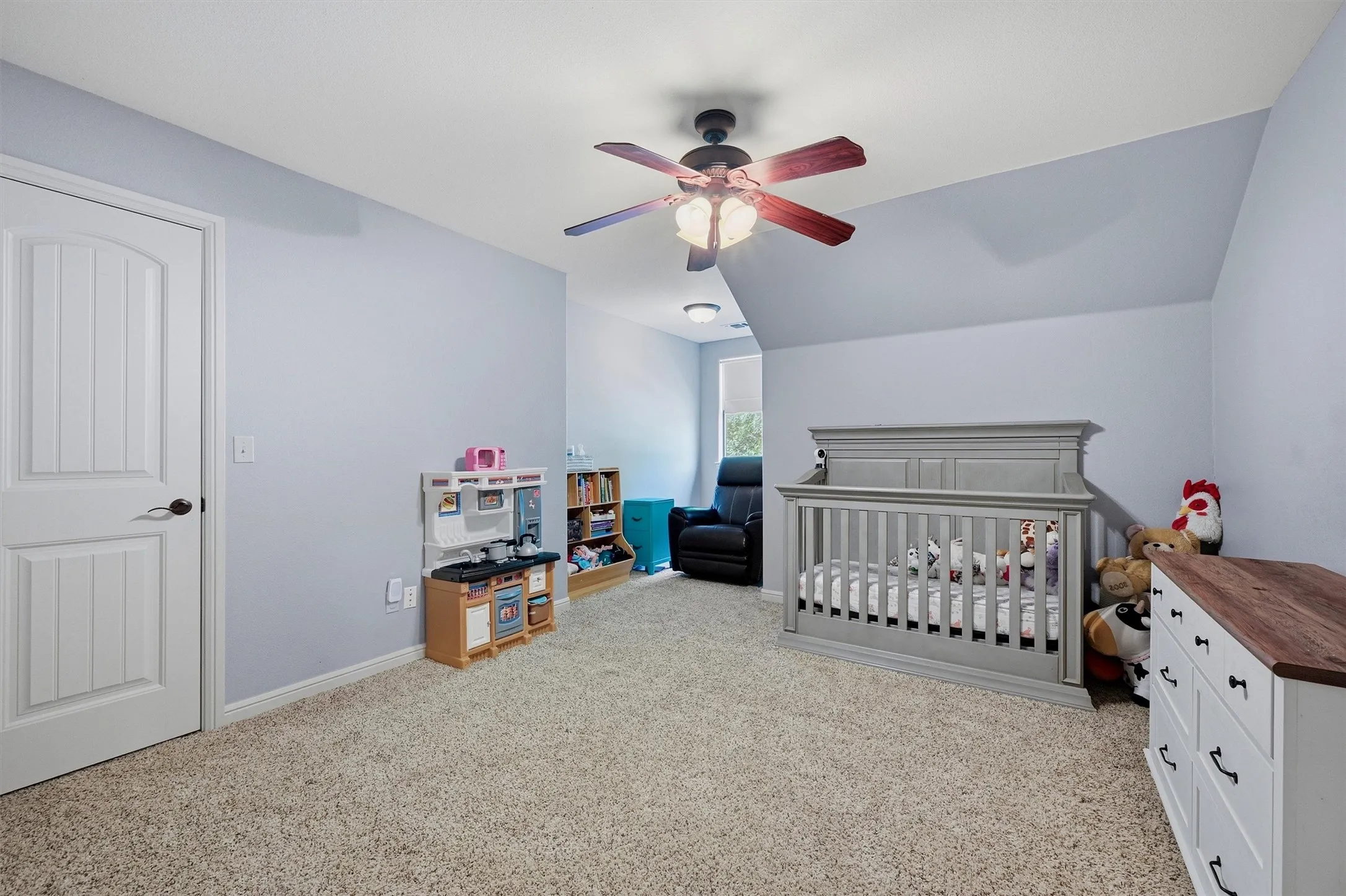 Interior room featuring light-colored carpet flooring and light blue wall paint
