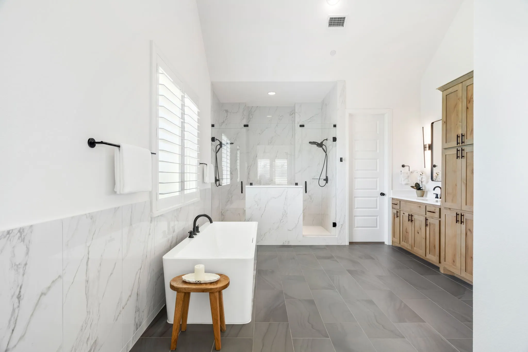 A breathtaking primary retreat boasting a contemporary freestanding tub, a grand double-sided shower, and an oversized walk-in closet.