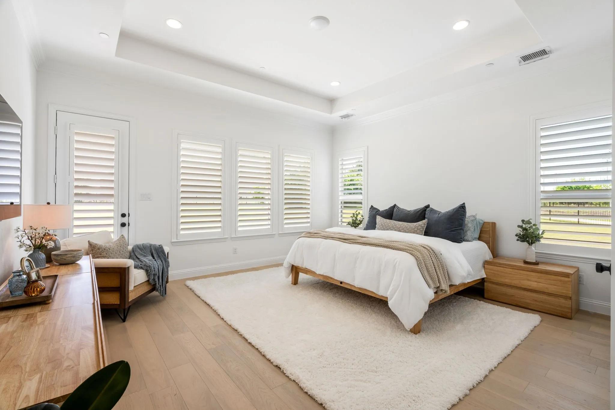 The primary bedroom serves as a personal retreat, blending indoor comfort with a private outdoor patio.
