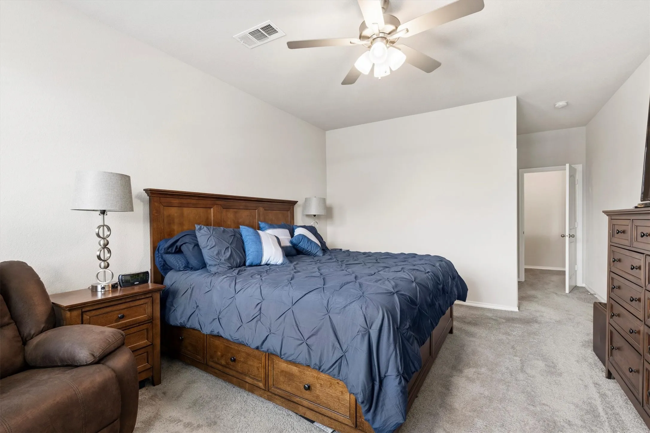 Neutral wall colors, vaulted ceiling, and grey carpeting