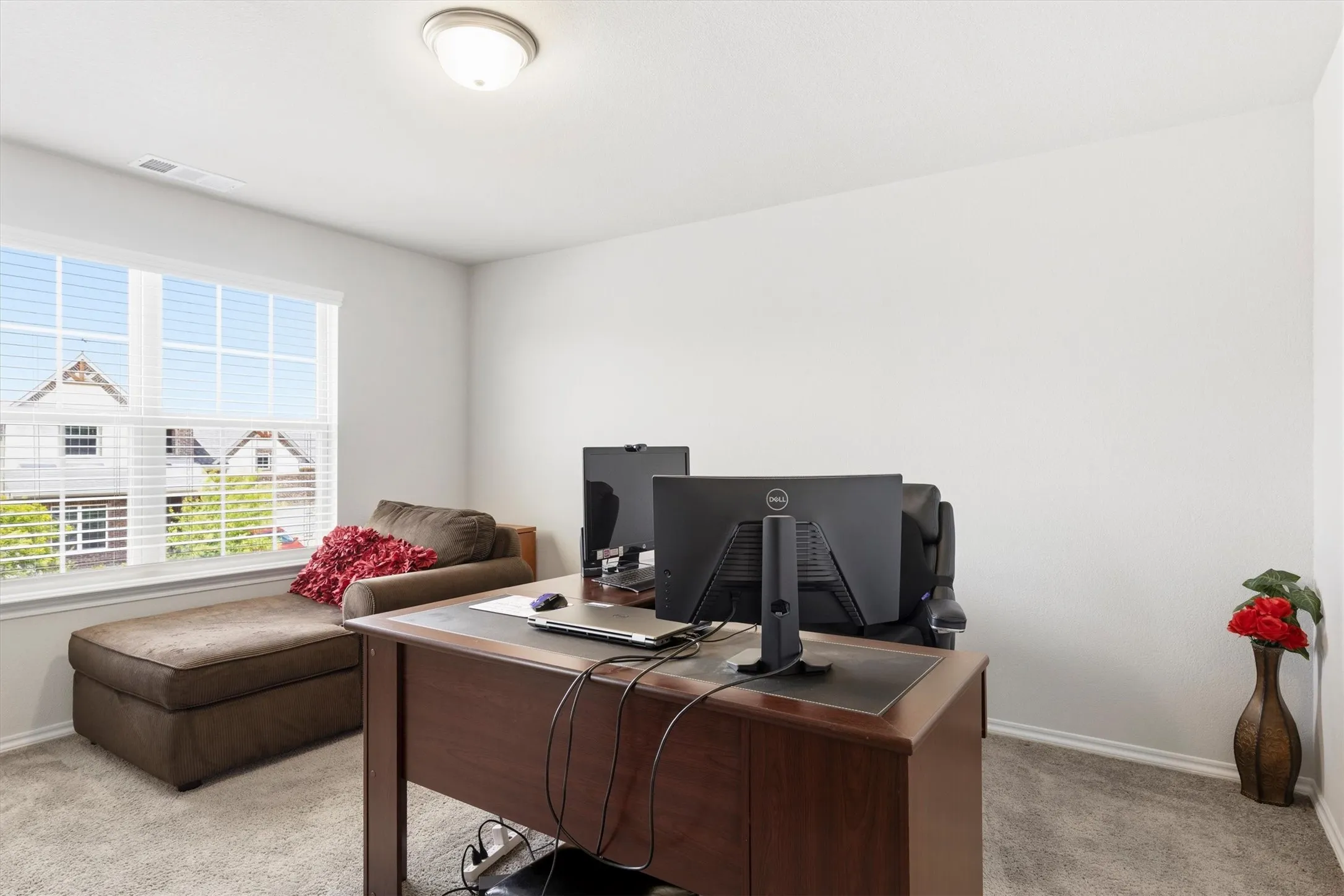 Bright interior room with light gray carpeting