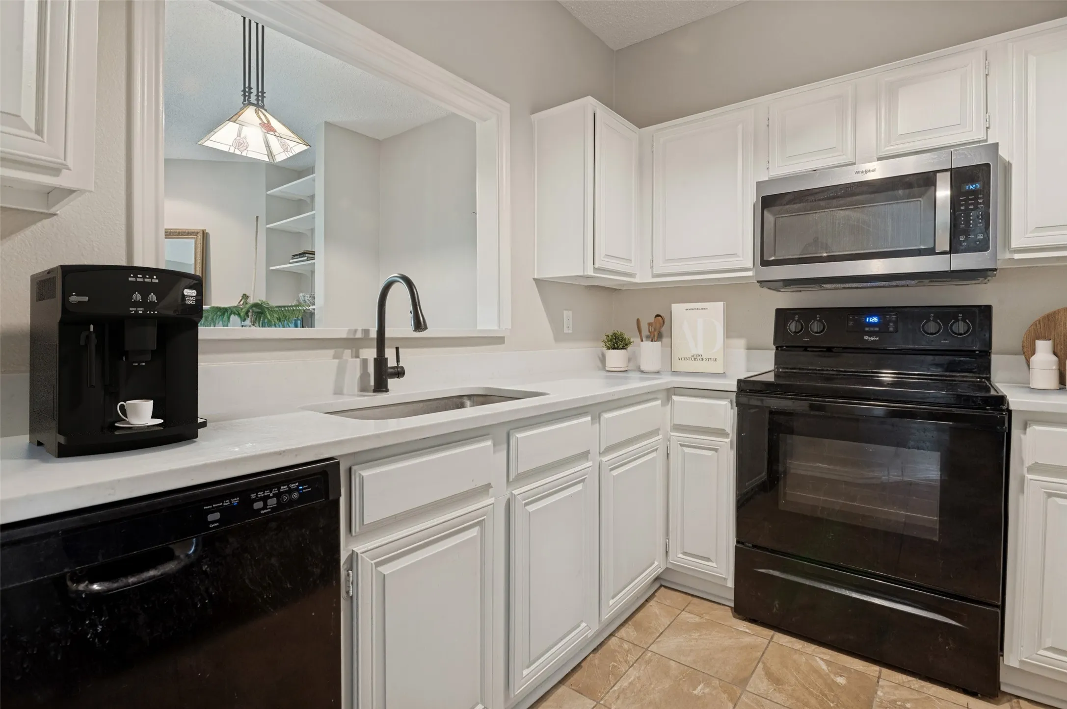 Kitchen was recently updated with quartz countertops, fresh paint and  a new stainless steel microwave