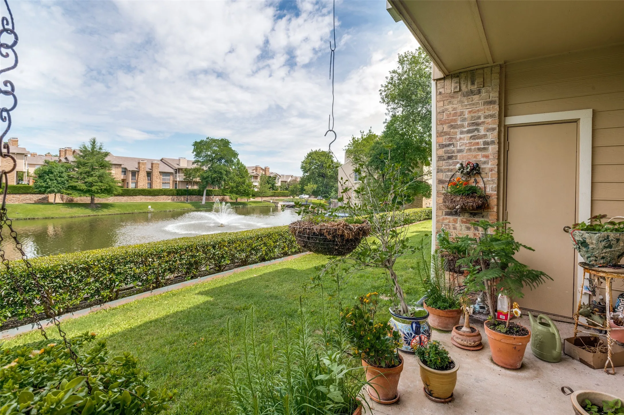 Covered patio facing the beautiful community lake with water feature.
