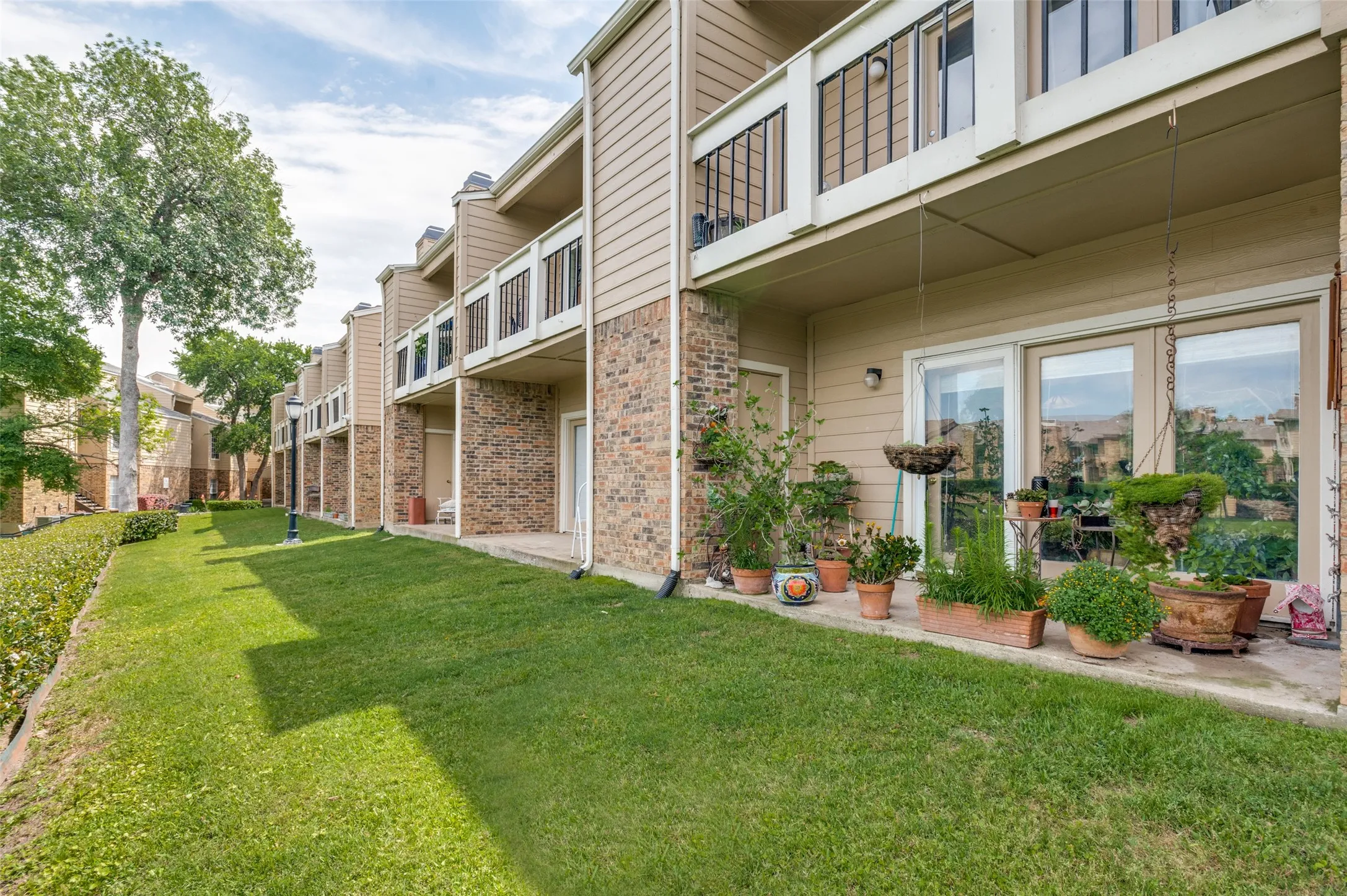 Covered patio facing the beautiful community lake with water feature.