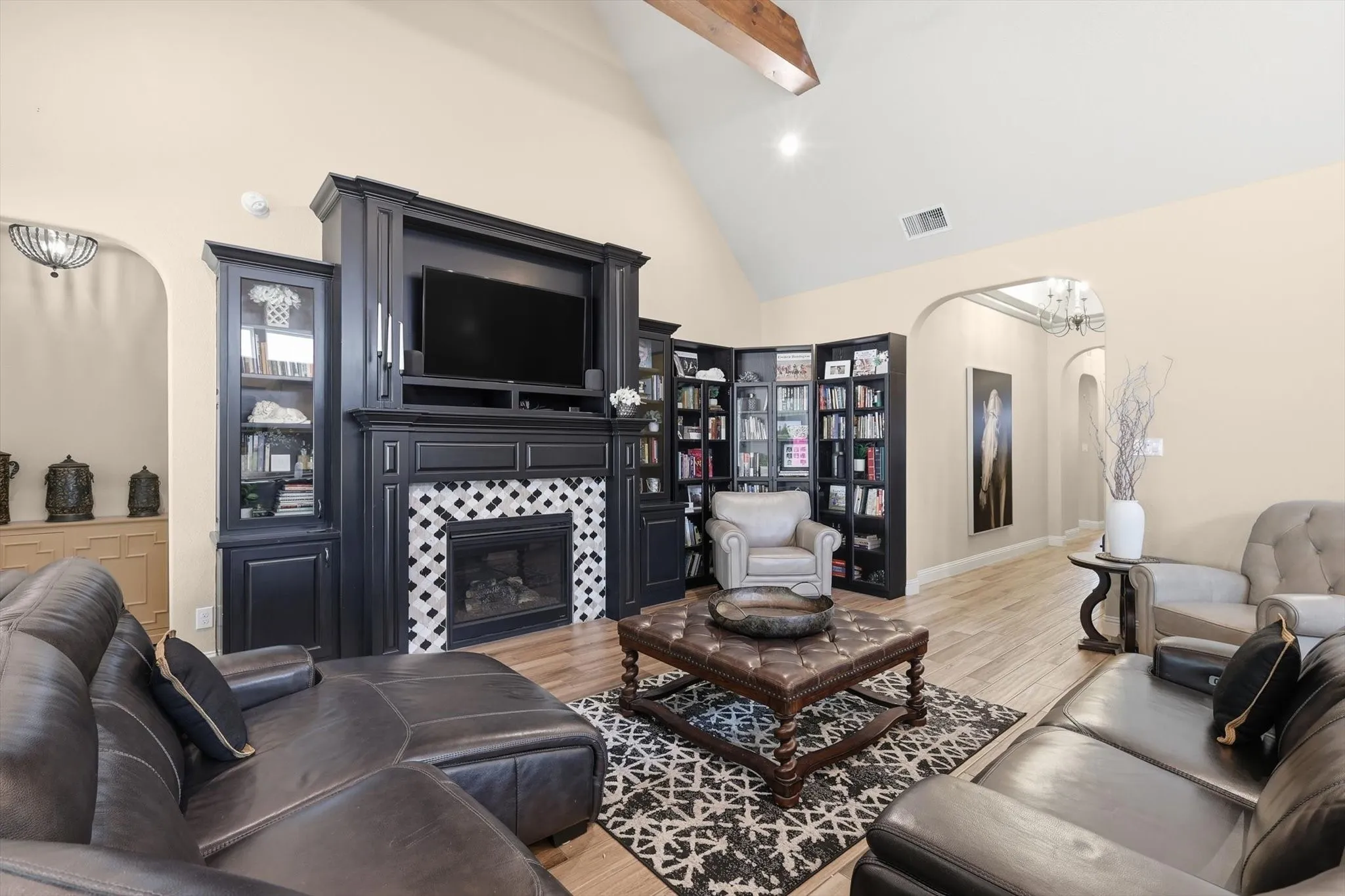 Living area with a vaulted ceiling and exposed wood beam