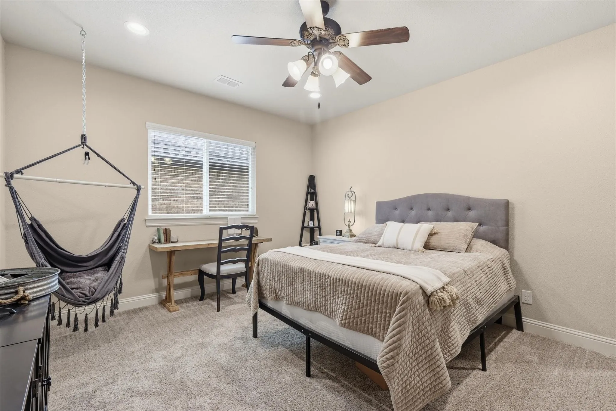 Carpeted room featuring a ceiling fan, recessed lighting, and a window with blinds