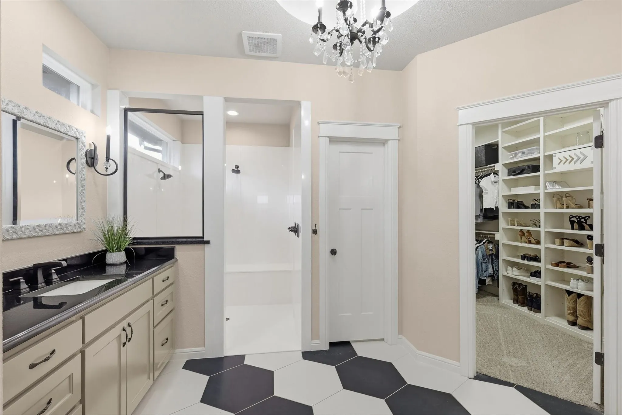 Bathroom with black and white hexagonal floor tiles