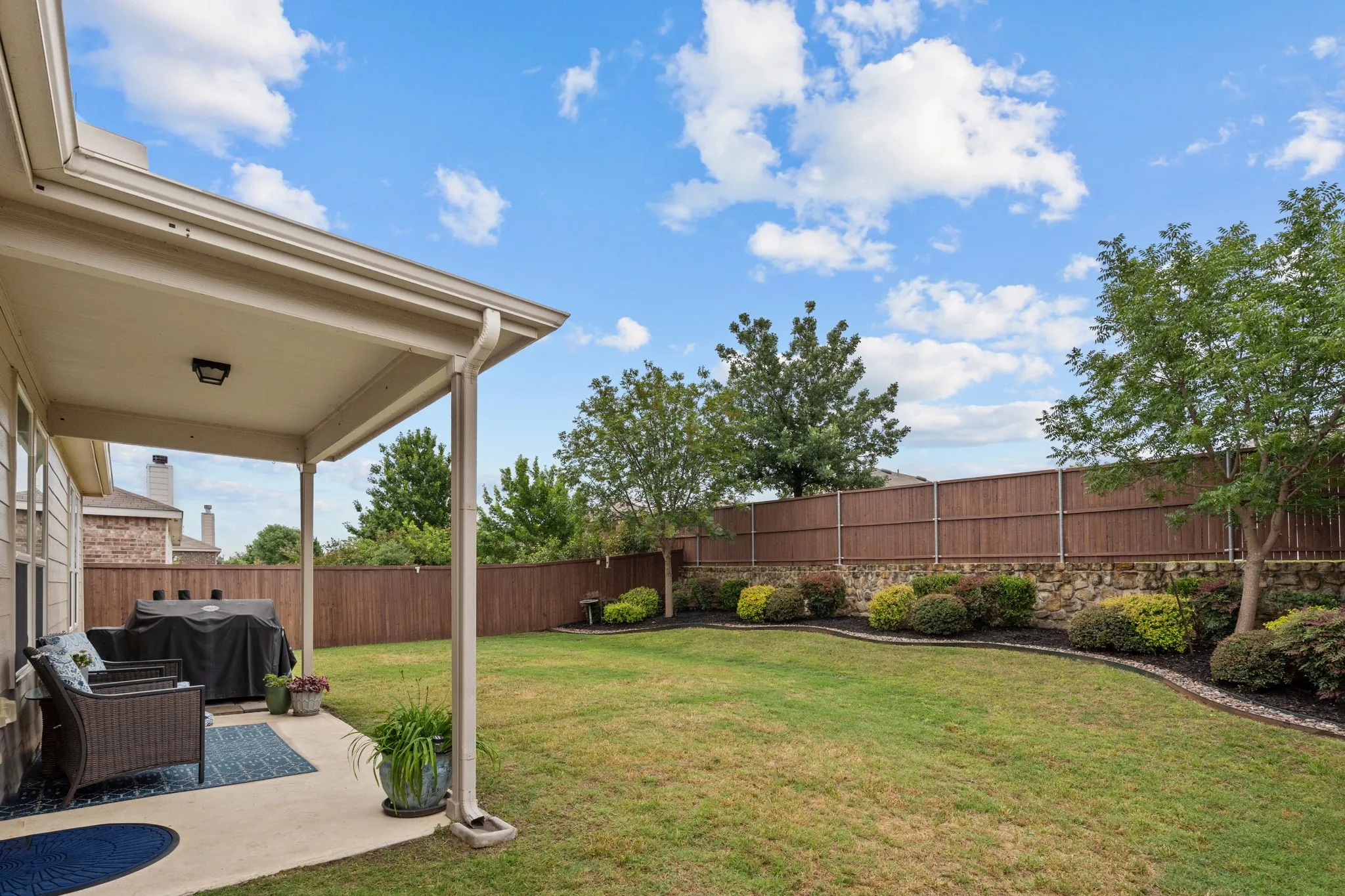 Don't settle for a home that has a long 'I can do that" list... Look at this backyard! It's manicured and ready for you to just move in and enjoy on your covered porch!