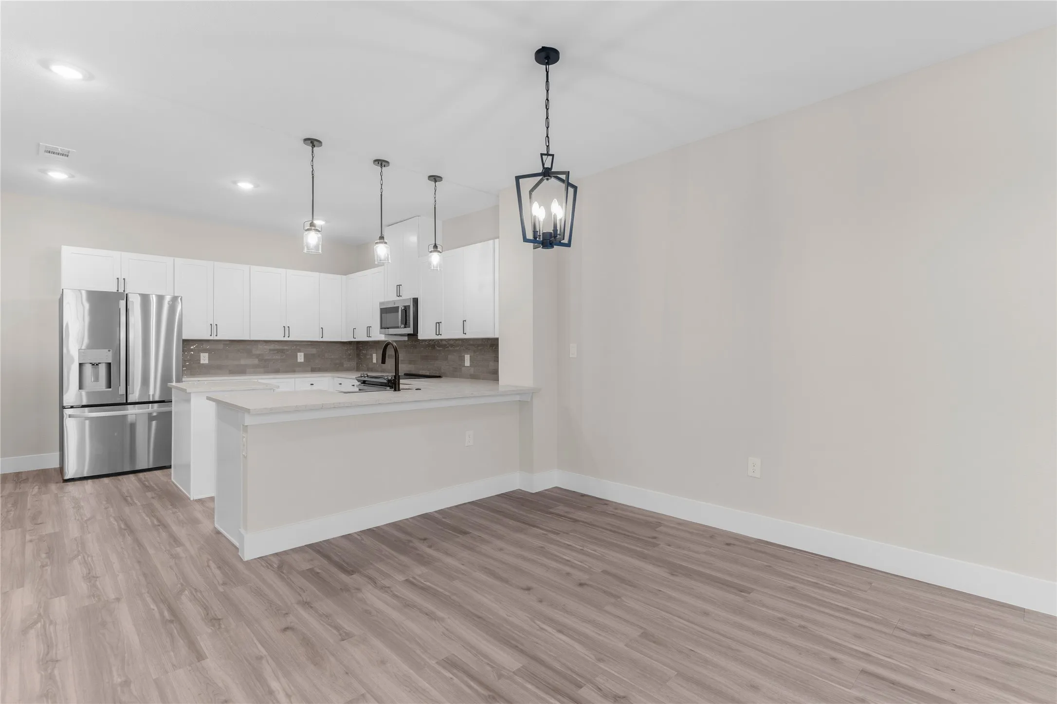 Open concept living space featuring wood-finish flooring