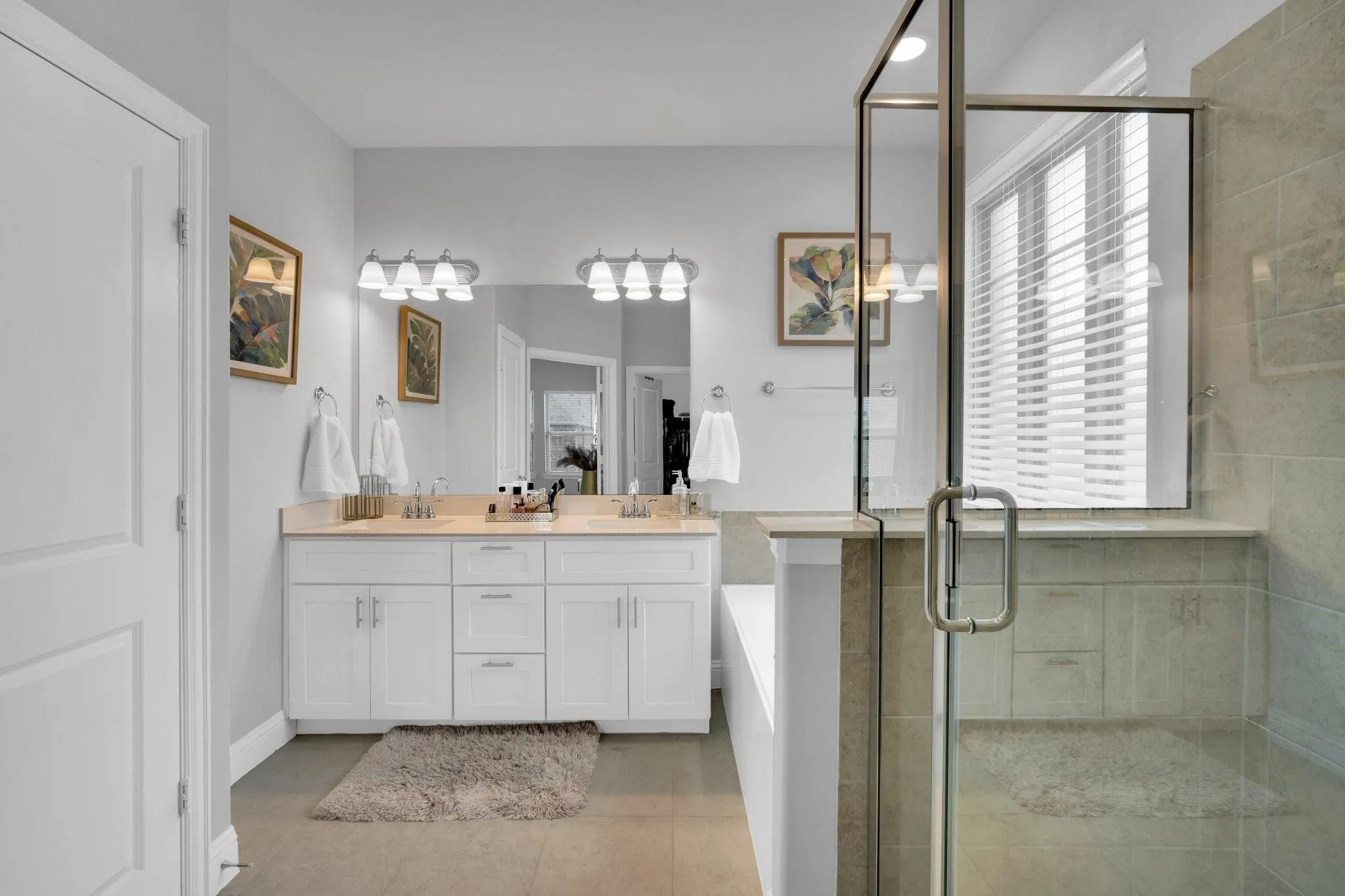Dual vanity with white cabinetry and light-toned countertops