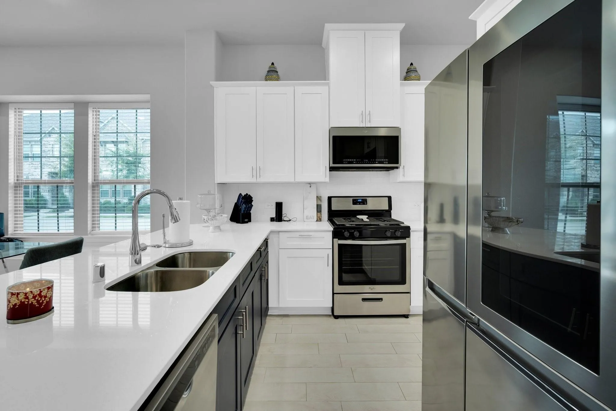 Kitchen featuring a stainless steel gas range, built-in microwave, and modern refrigerator