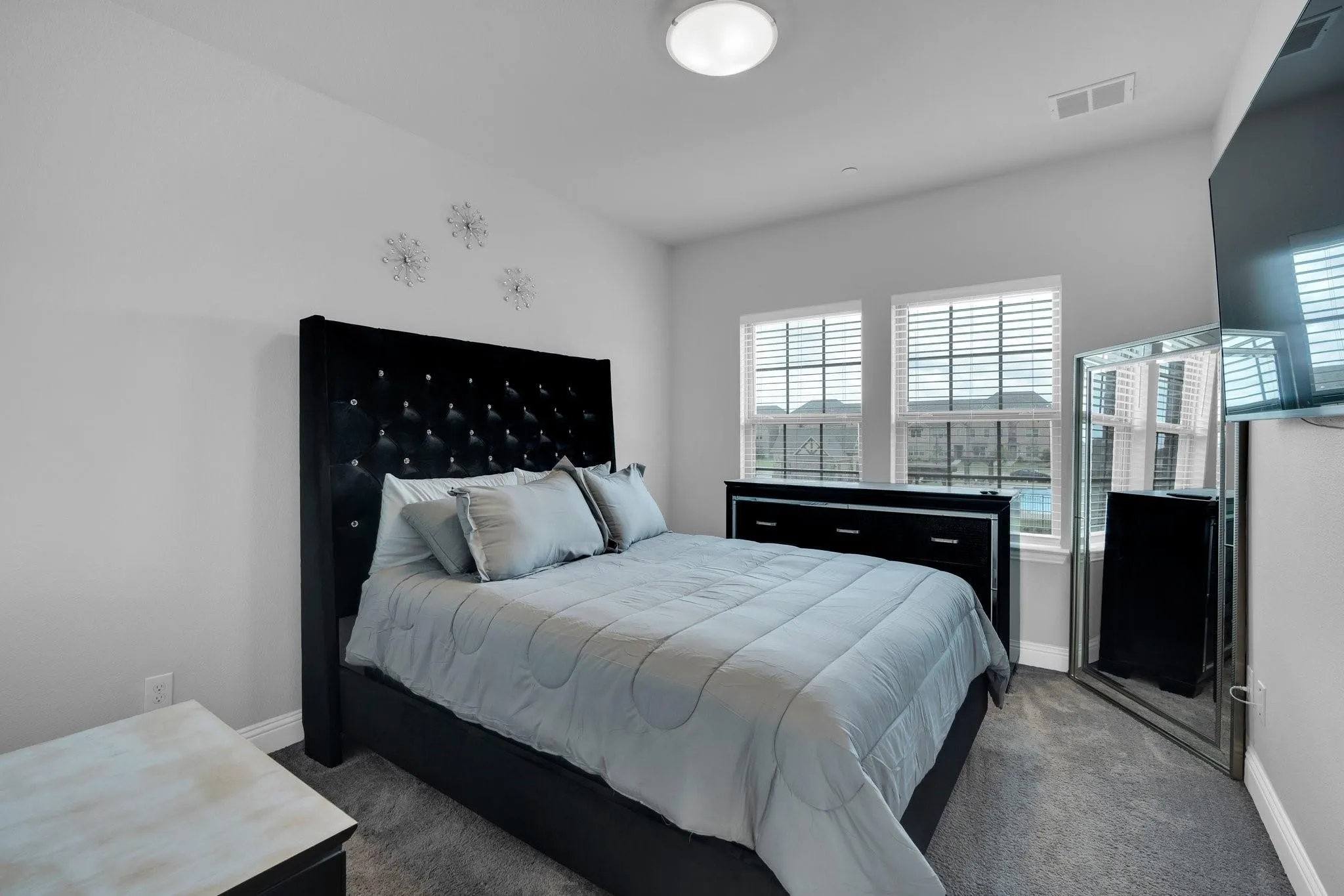 Carpeted room featuring a white ceiling and walls