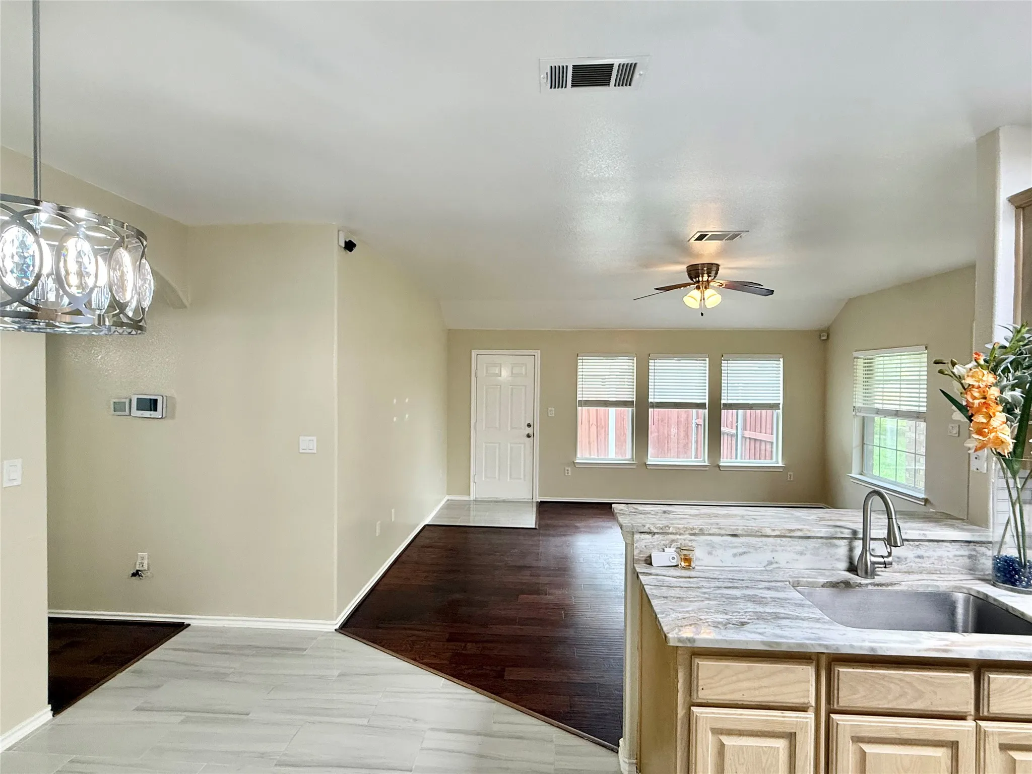 Kitchen featuring light wood cabinetry, a stainless steel undermount sink, and light-toned countertops