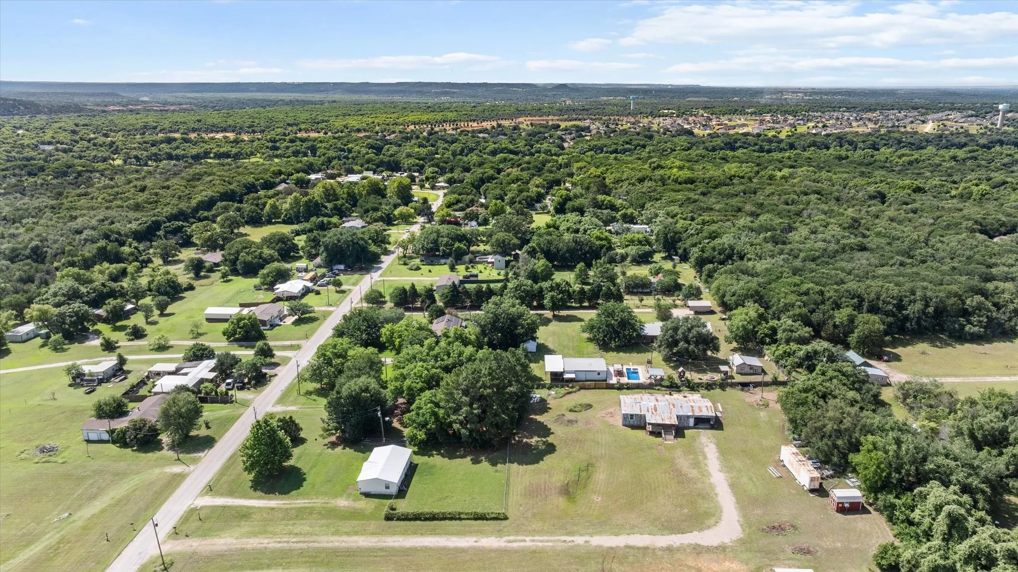 Expansive aerial perspective showcasing a residential area with varied housing styles amidst abundant greenery