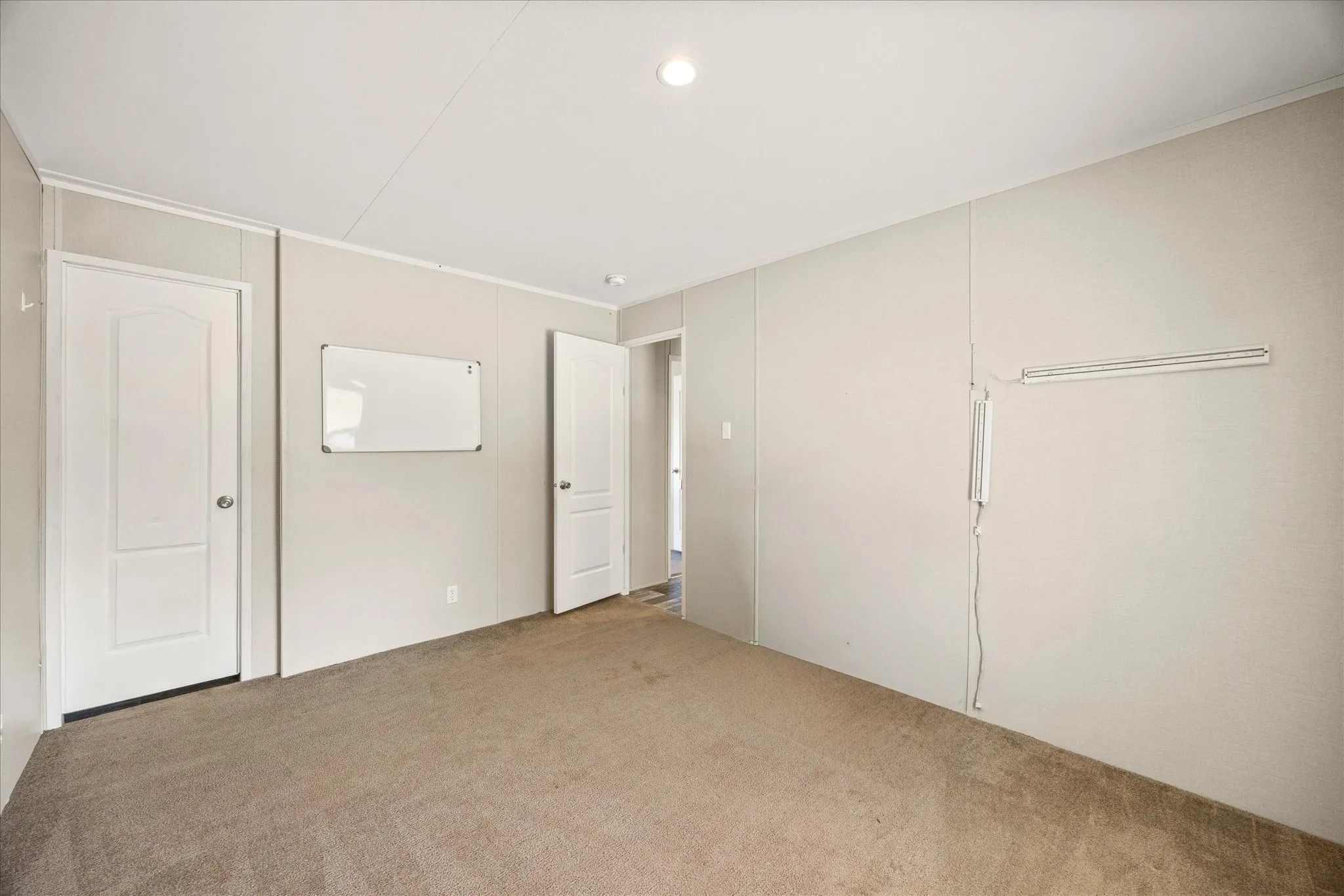 Neutral-toned carpeting spans the floor, complemented by light-colored walls