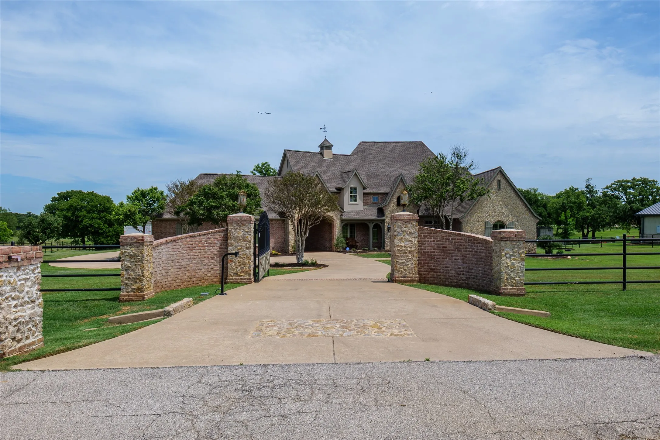 View of the home as you drive up to the electric gate