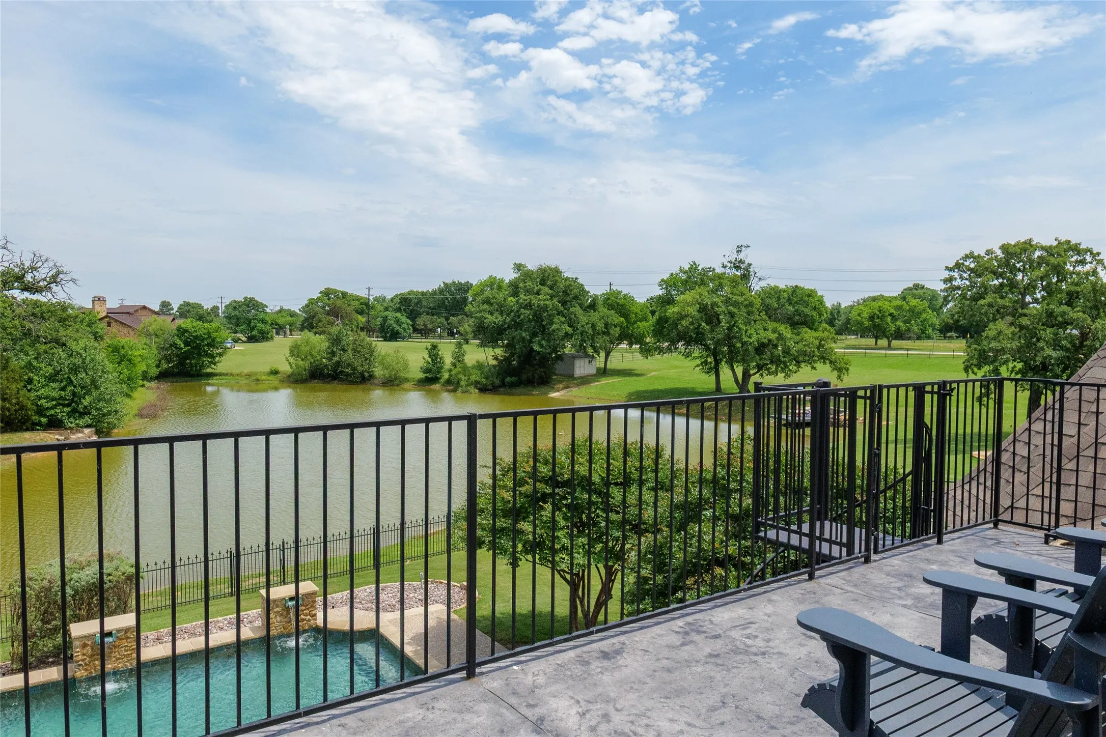 Upstairs balcony off of the gameroom captures stunning views of the pond and pool area