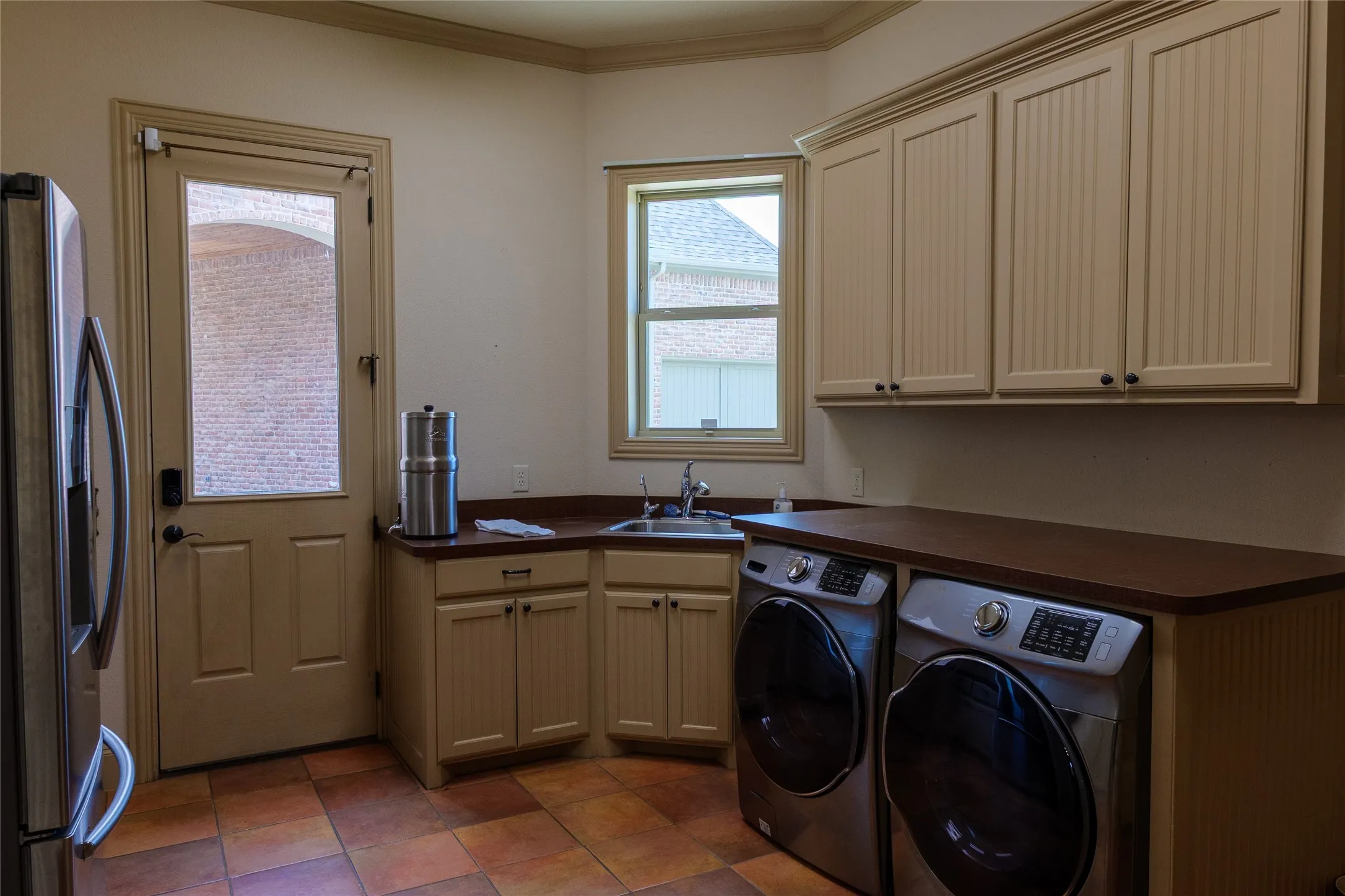 Oversized laundry room with a utility desk and room for fridge or freezer