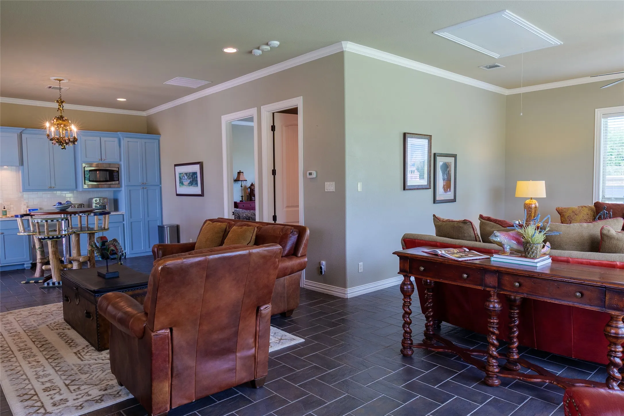 Multiple living spaces in the guest house with the main living featuring a fireplace. Off the main living is the bedroom with bath
