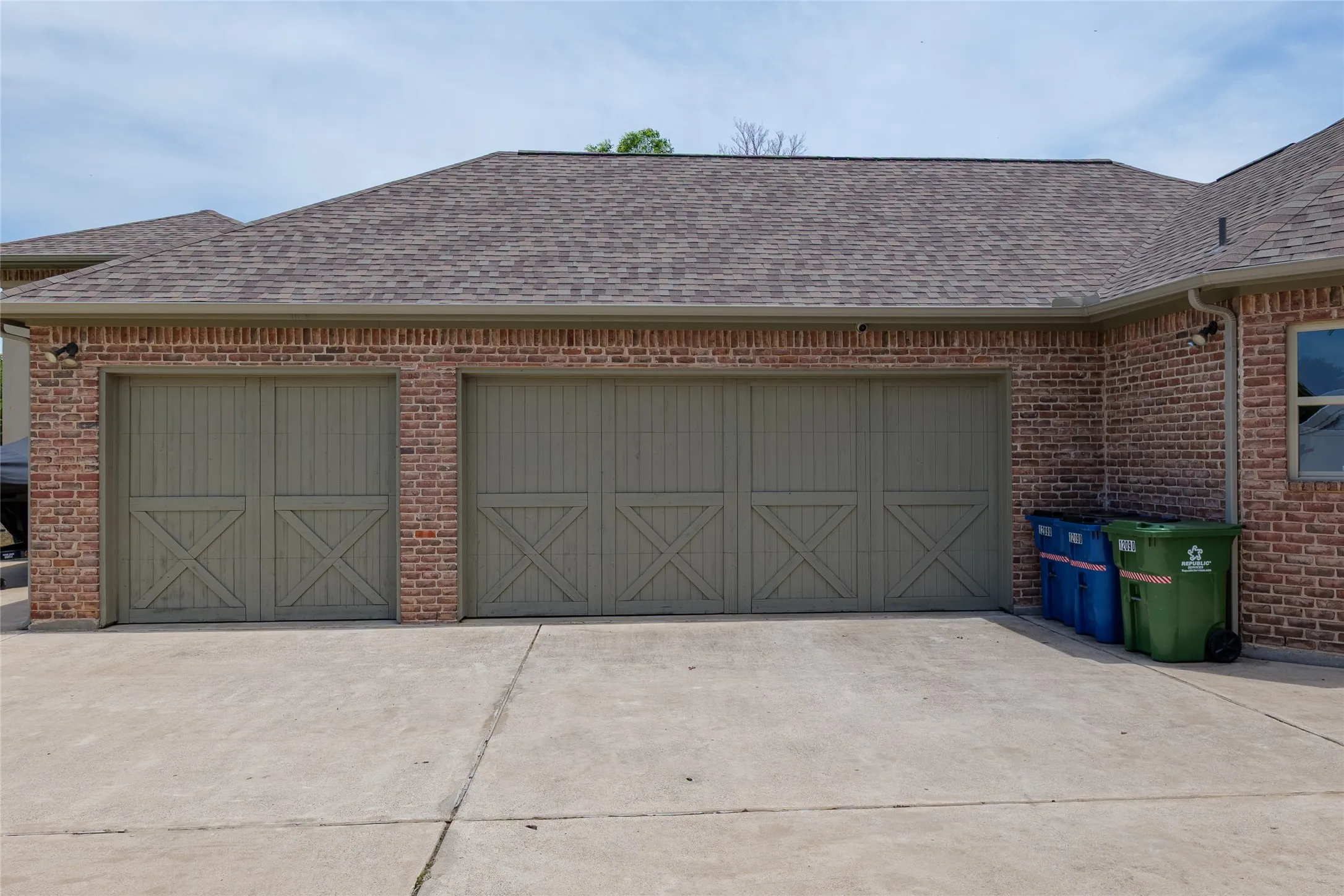view of 3-car garage as you pull into the drive leading to the parking spaces