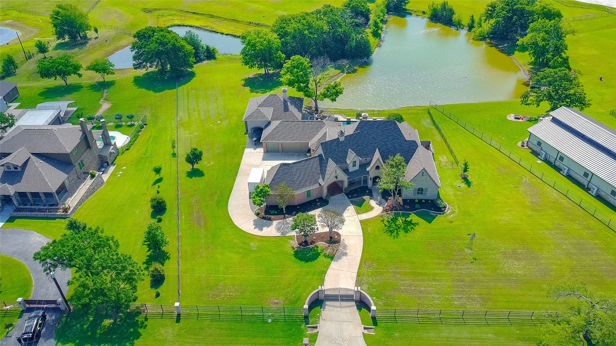 Excellent aerial view showcasing the home with the view of the pond