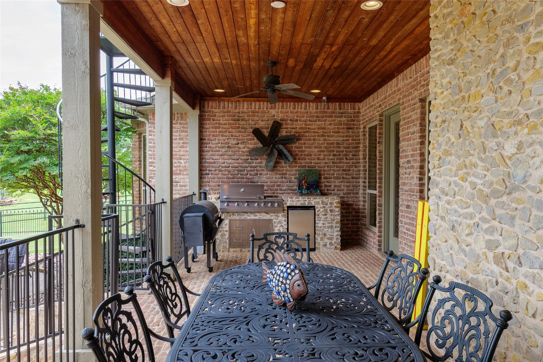 Covered patio with view of built-in grill area