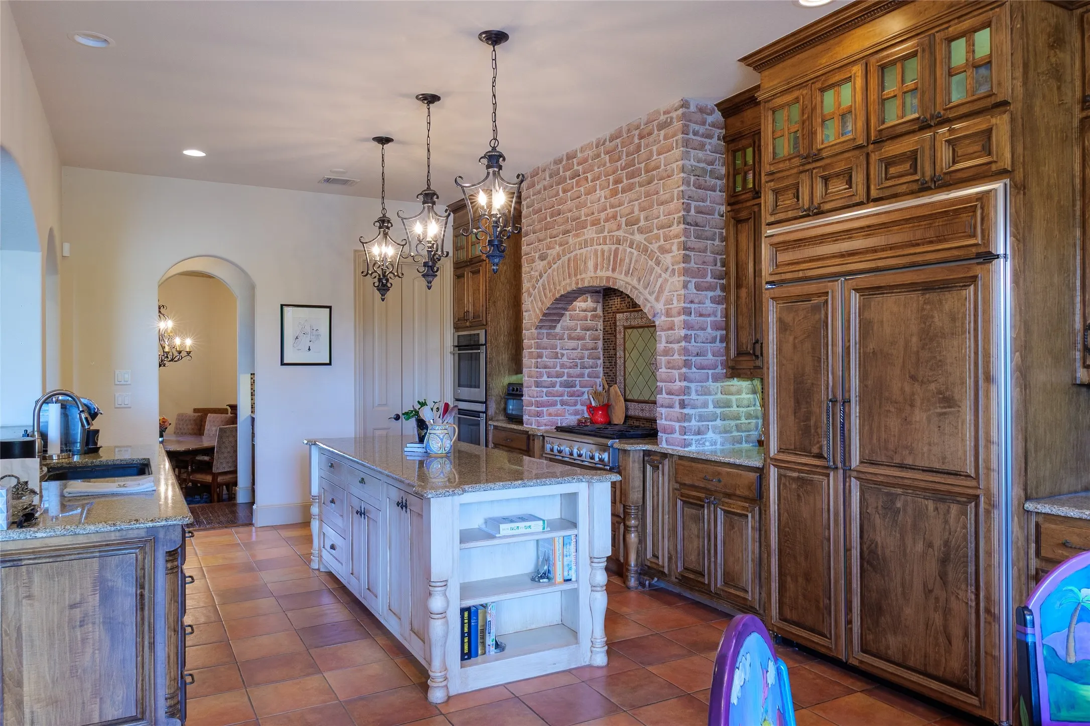 View of kitchen from breakfast nook looking towards the archway that leads you to a wine closet & butler's pantry - Kitchen also features a large walk-in pantry