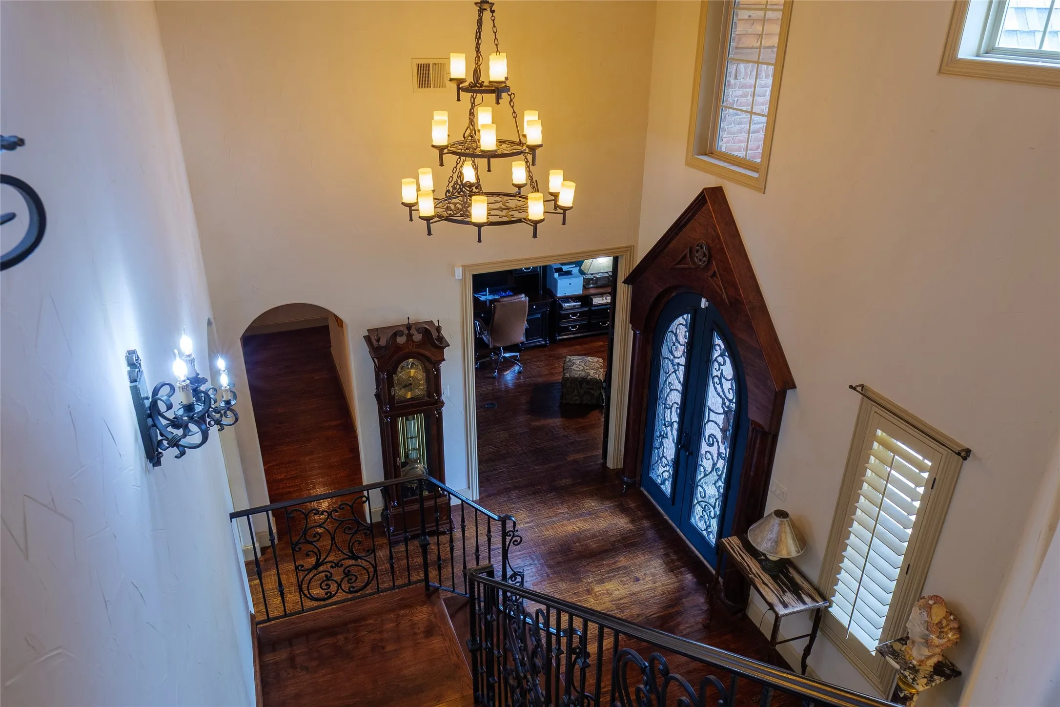 View from the top of the stairs looking down into the front entry and the study