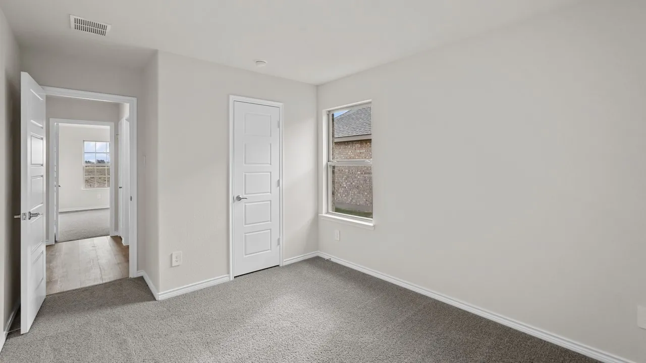 Carpeted room featuring a single window and two panel doors