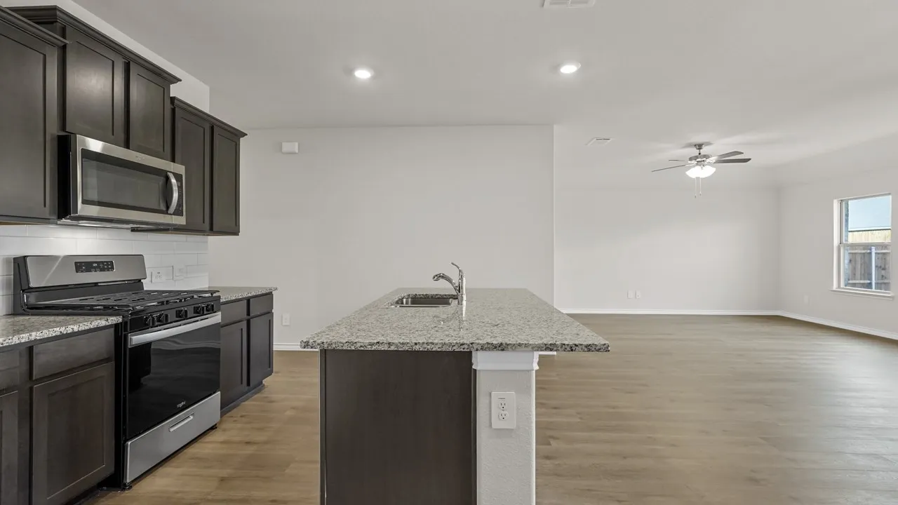 Modern kitchen island with an undermount sink and granite countertop