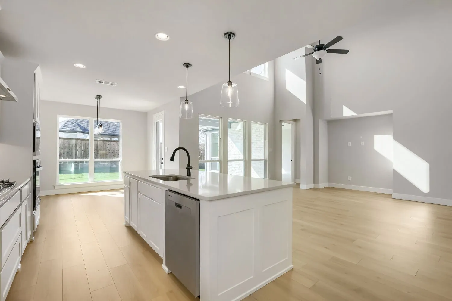 Open-concept living space with high ceilings and wood-finish flooring