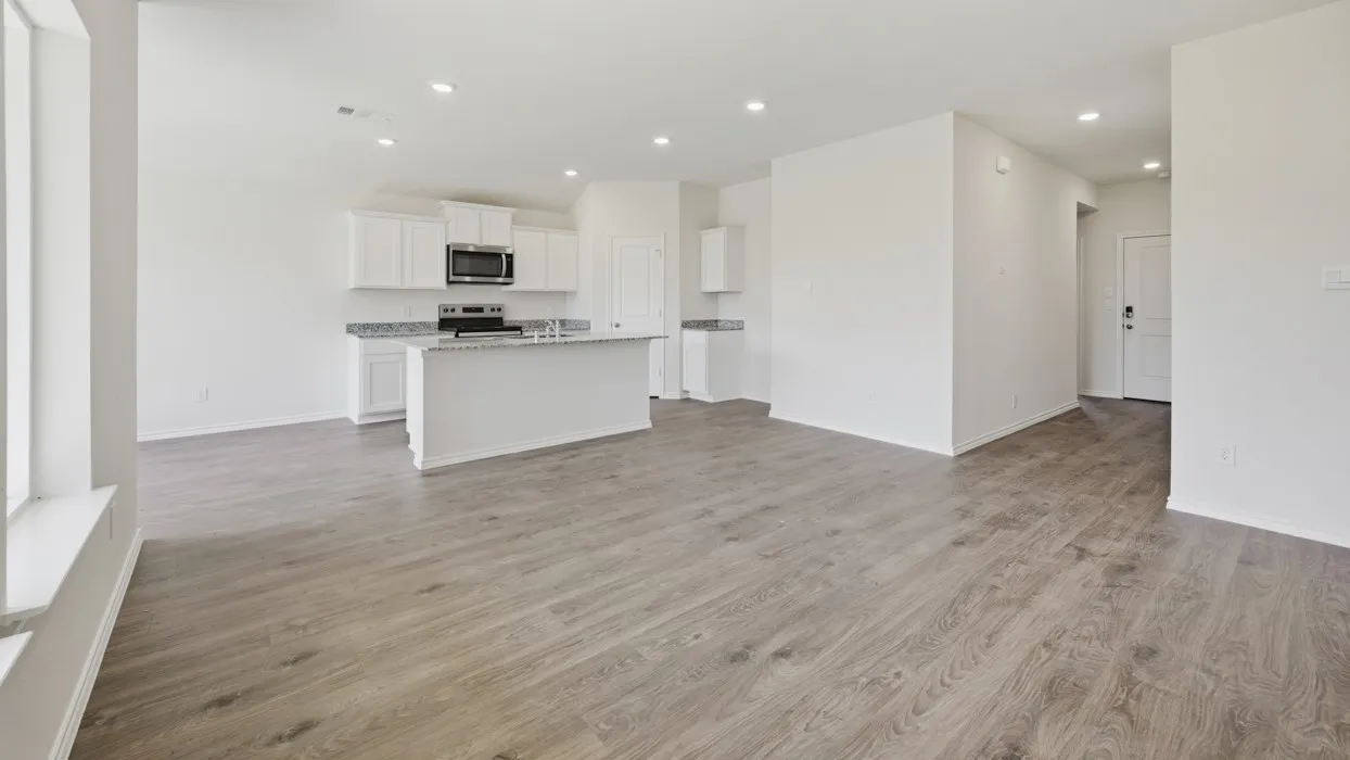Open-concept living space featuring wood-finish flooring throughout