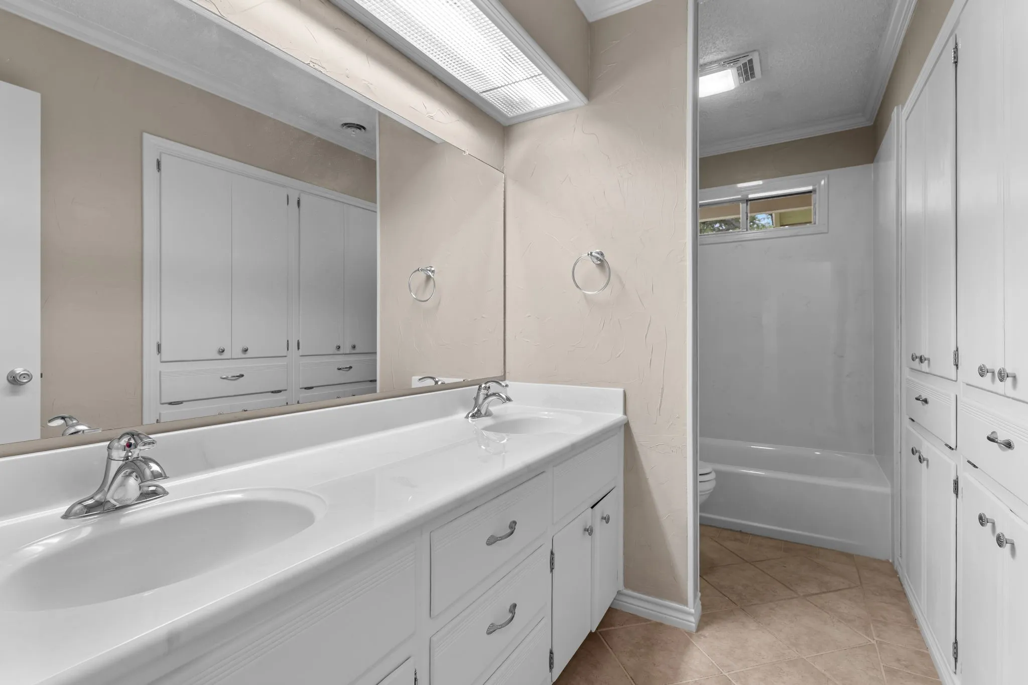 Double vanity with integrated sinks and chrome fixtures
