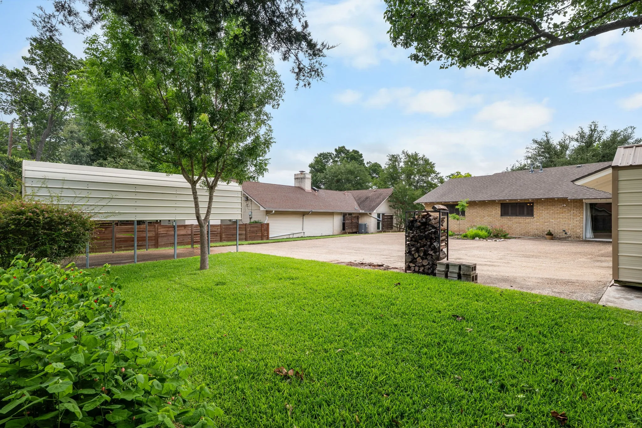 Expansive gravel driveway featuring multiple structures