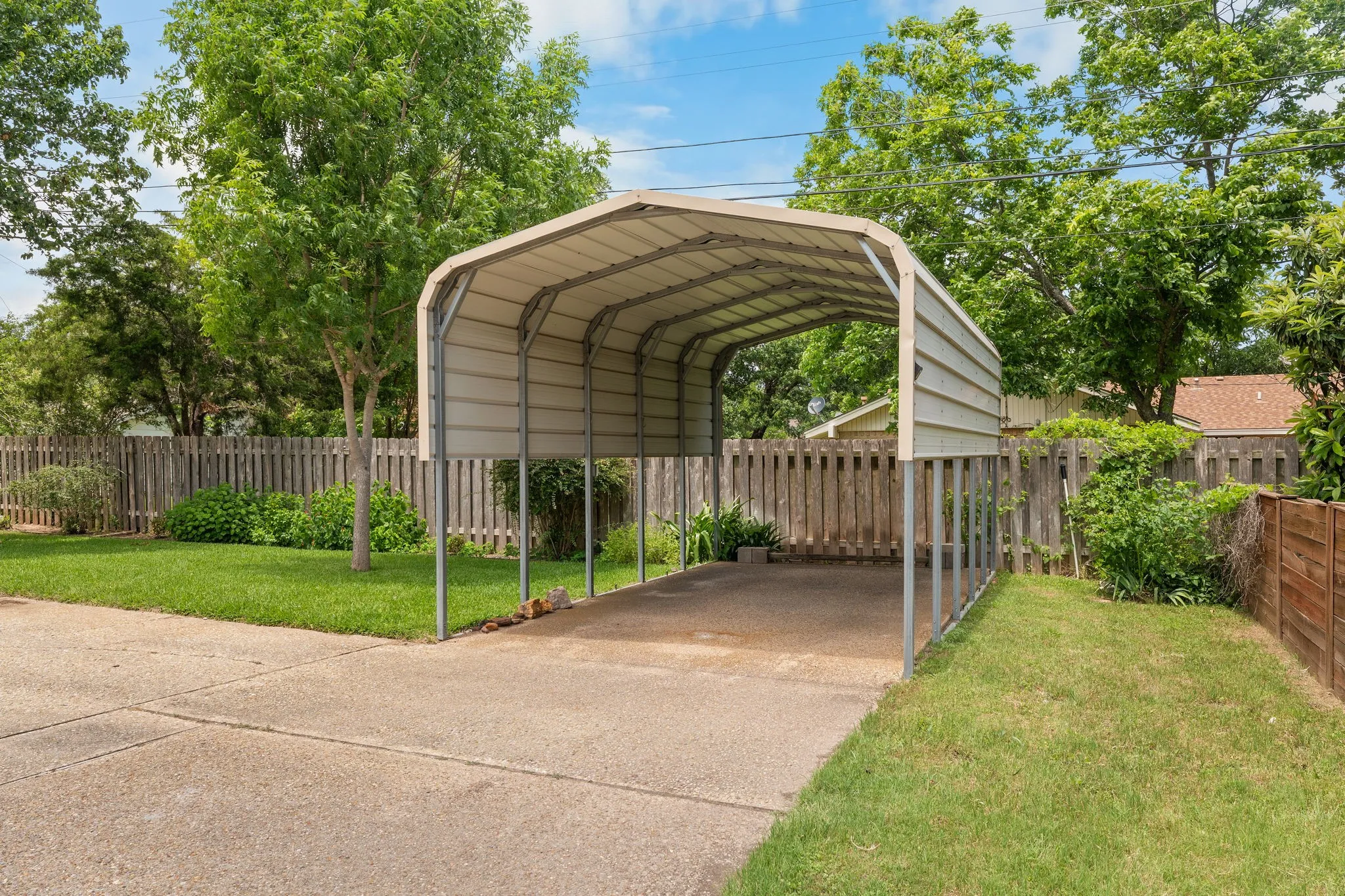 Detached metal carport structure providing covered parking