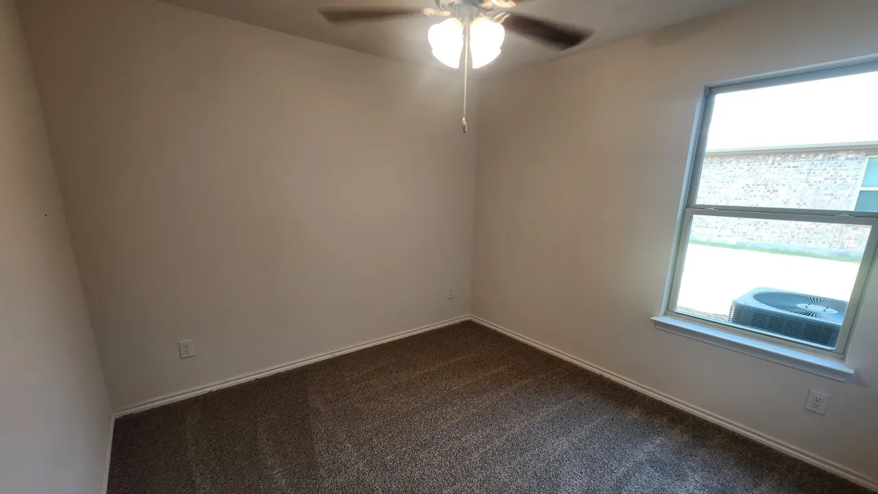 Neutral-toned walls and a large window providing natural illumination