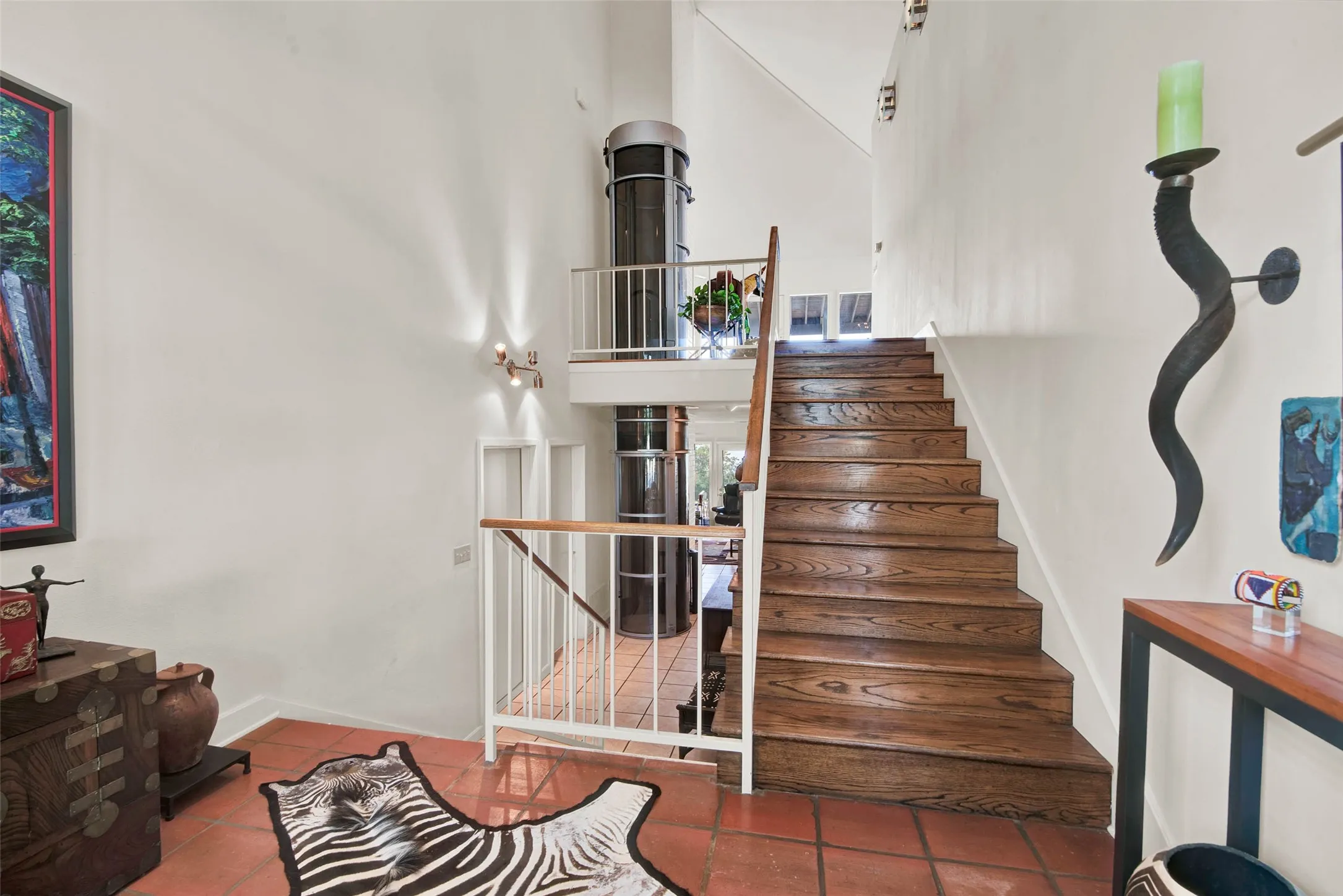 First level as you enter front door. Stairs leading to second level and elevator entrance.