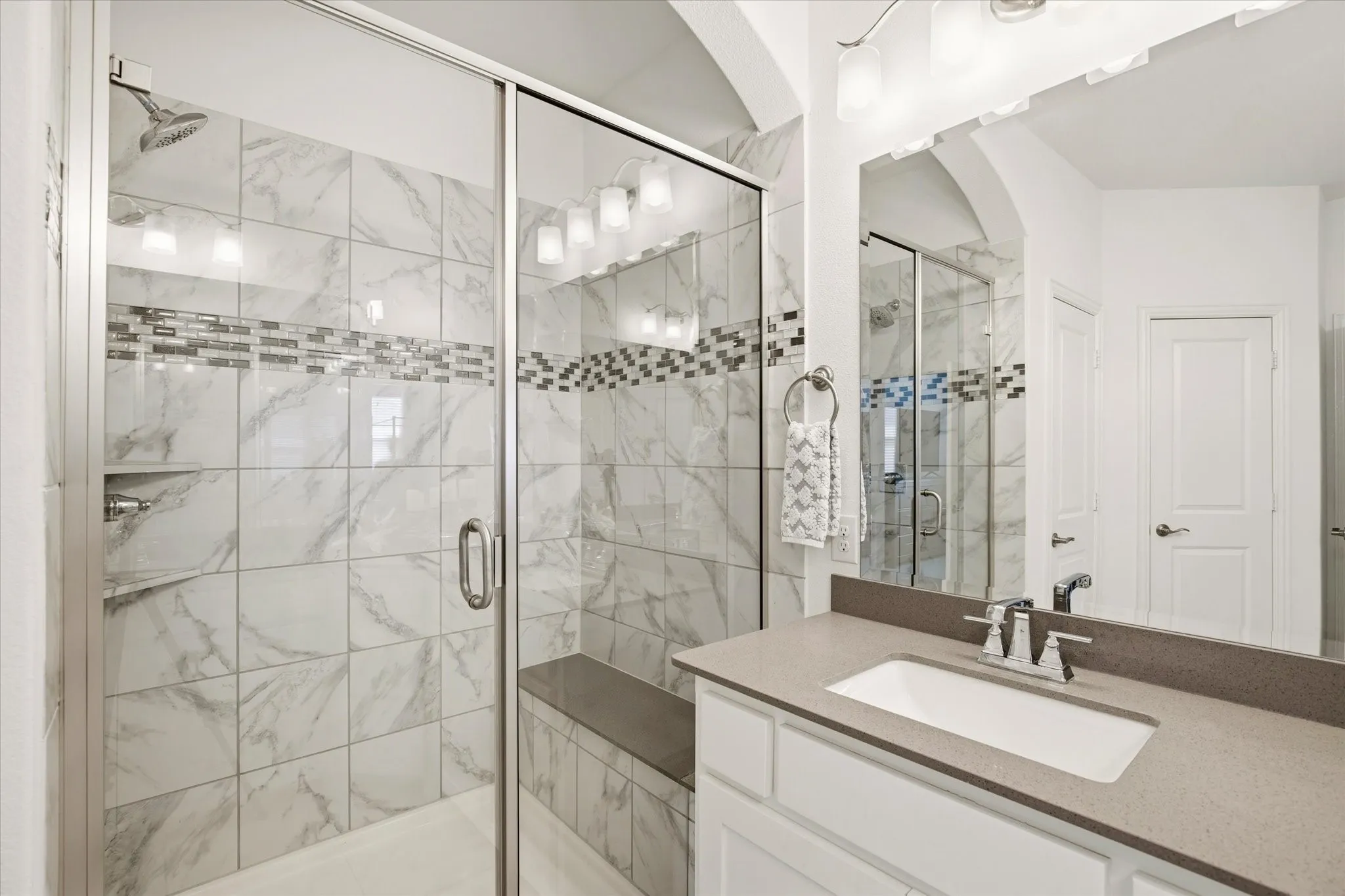 An oversized shower is perfect in this large primary bathroom.