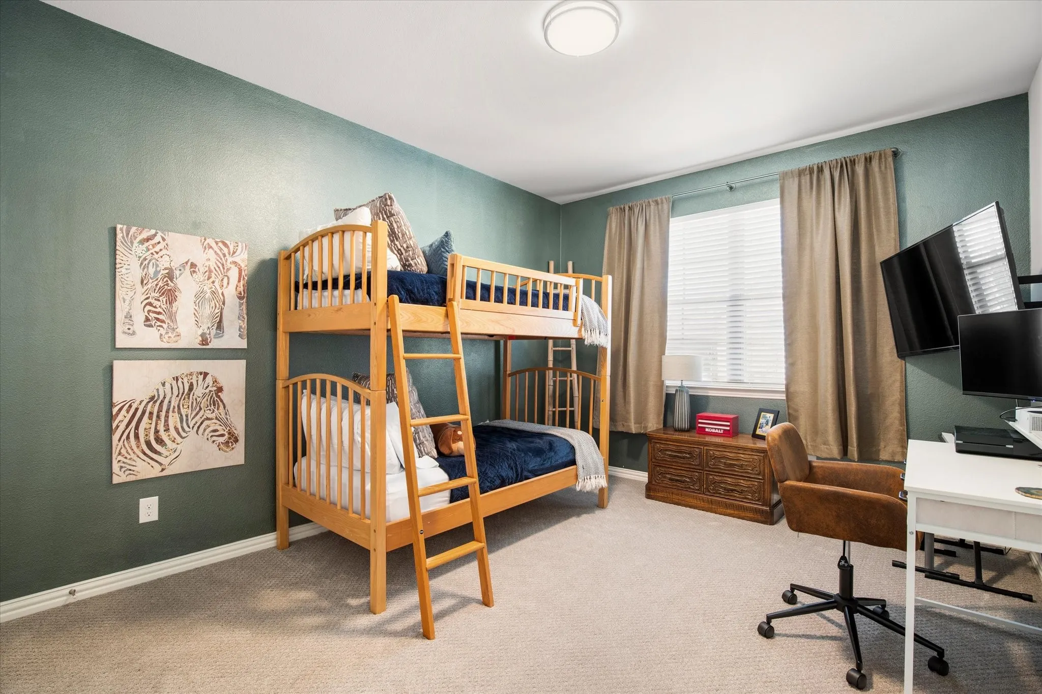The guest bedroom has plenty of room for kids or guests with another large window.