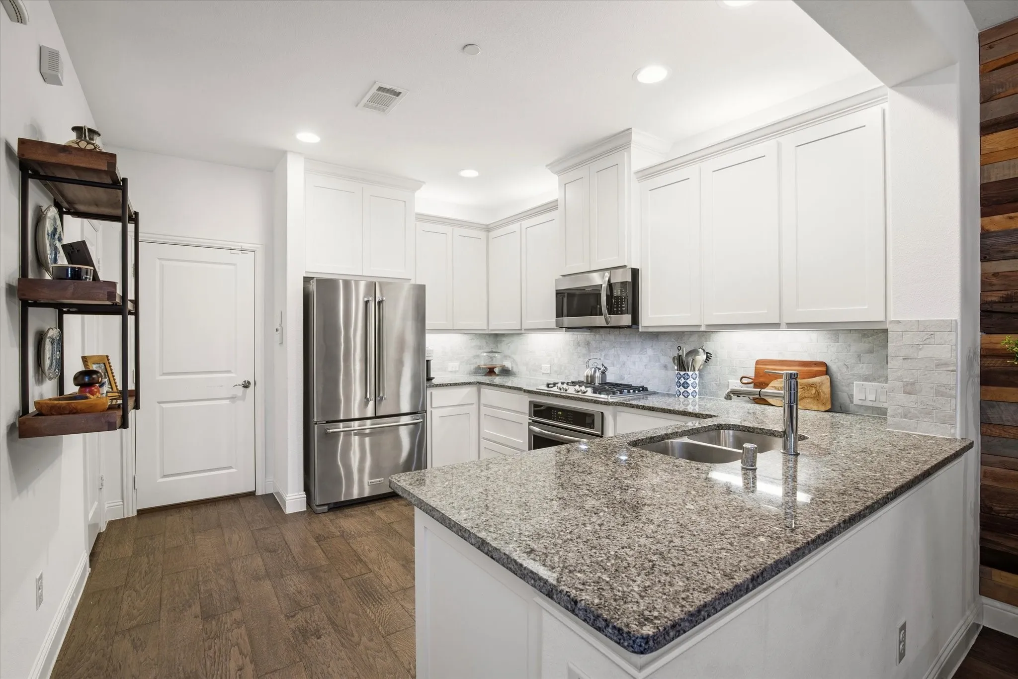 The kitchen has a large peninsula dividing the rooms.