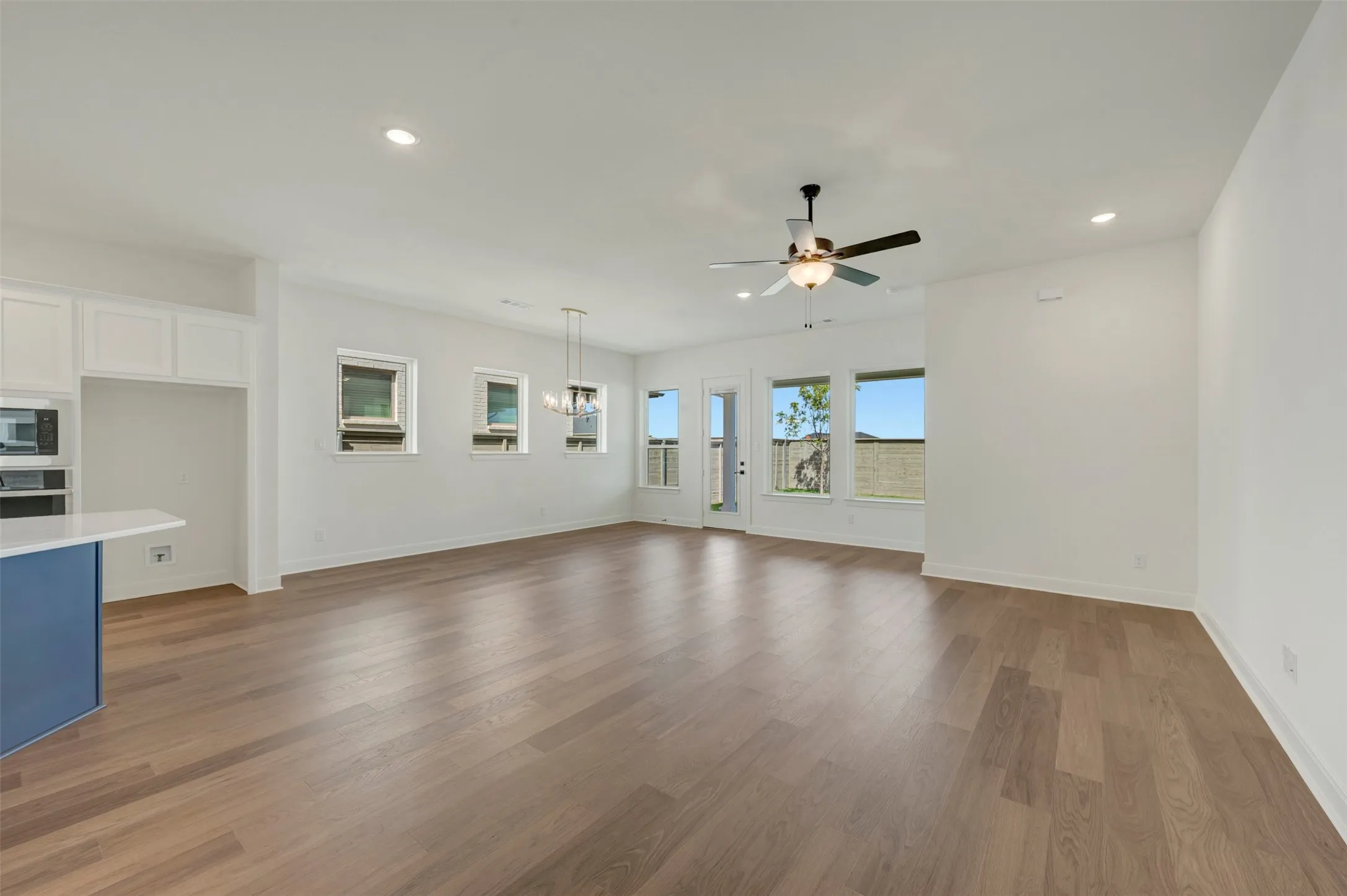 Open concept living area featuring wood-finish flooring, recessed lighting, and a ceiling fan