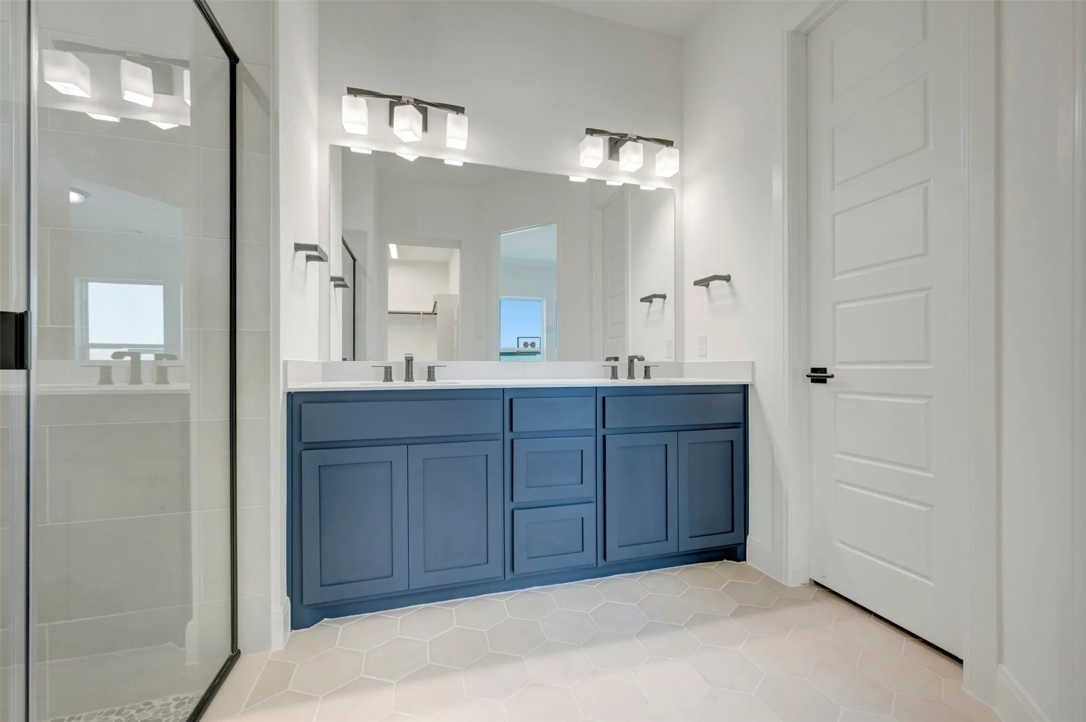 Dual vanity with blue cabinetry, white countertop, and rectangular undermount sinks